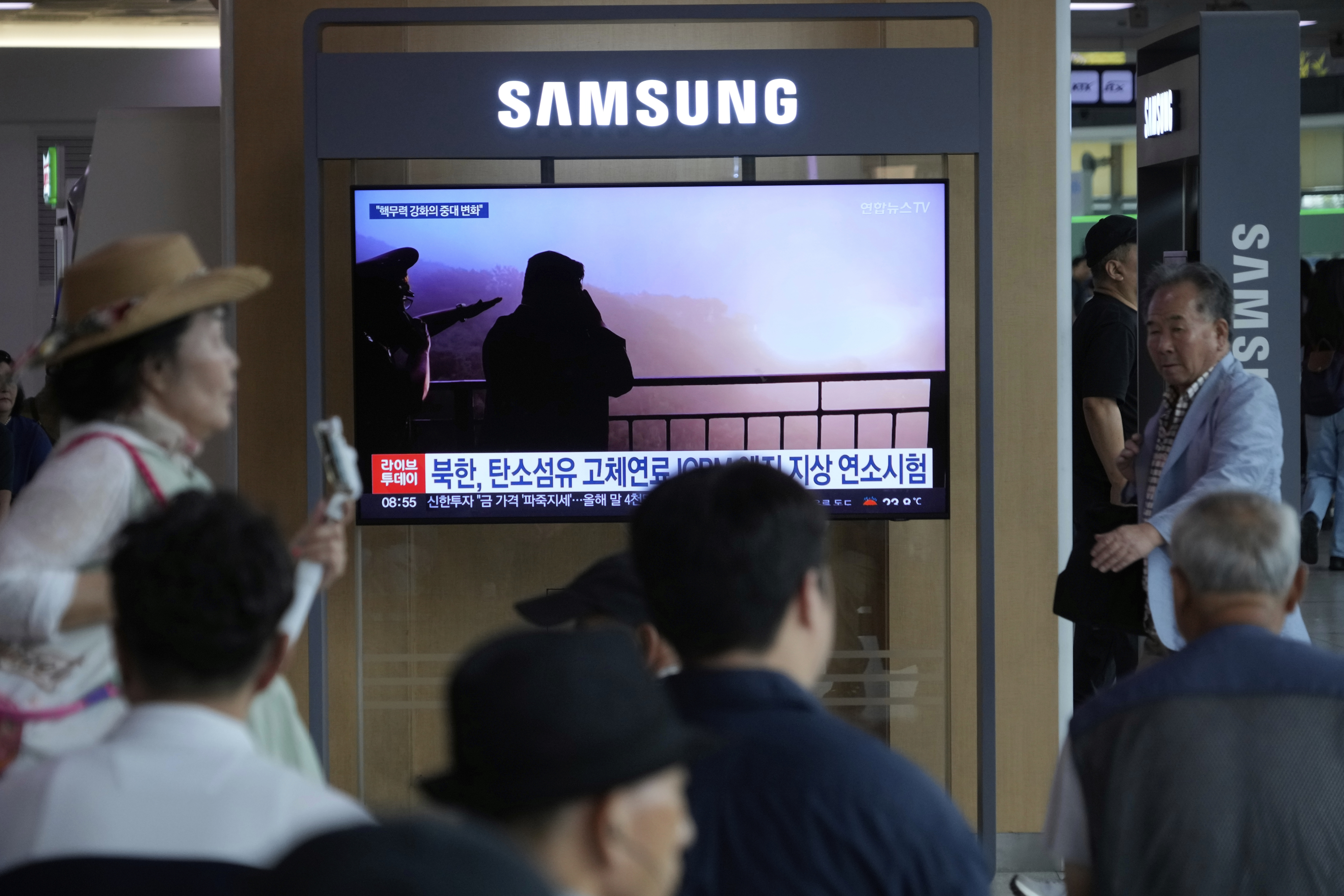 A TV screen shows an image of North Korean leader Kim Jong Un, second from right, supervising a test of a new rocket engine during a news program at the Seoul Railway Station in Seoul, South Korea, Tuesday, Sept. 9, 2025. (Ahn Young-joon - AP)