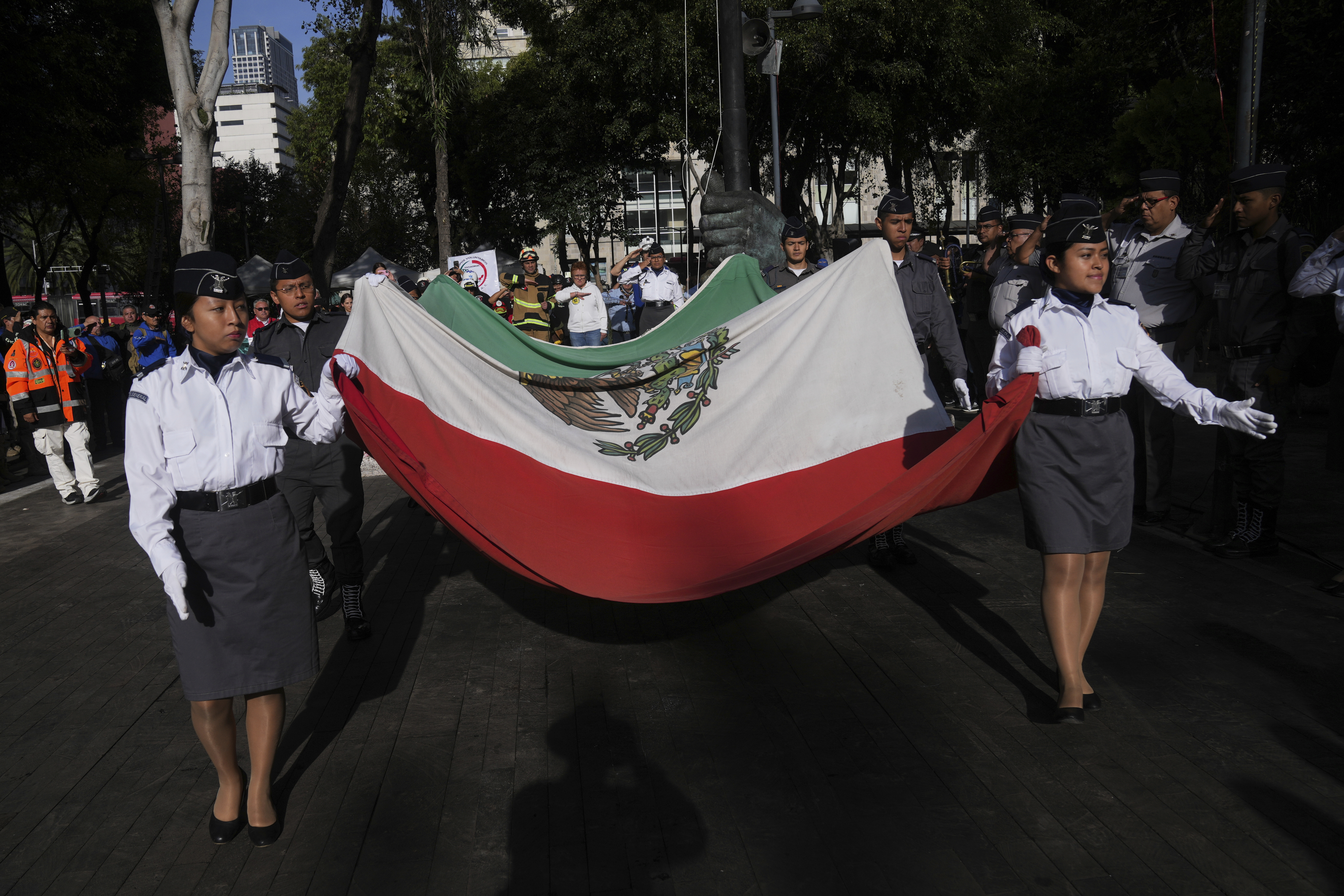 Military school cadets carry a Mexican flag during a ceremony marking the 1985 earthquake's 40th anniversary in Mexico City, Friday, Sept. 19, 2025. (Marco Ugarte - AP)