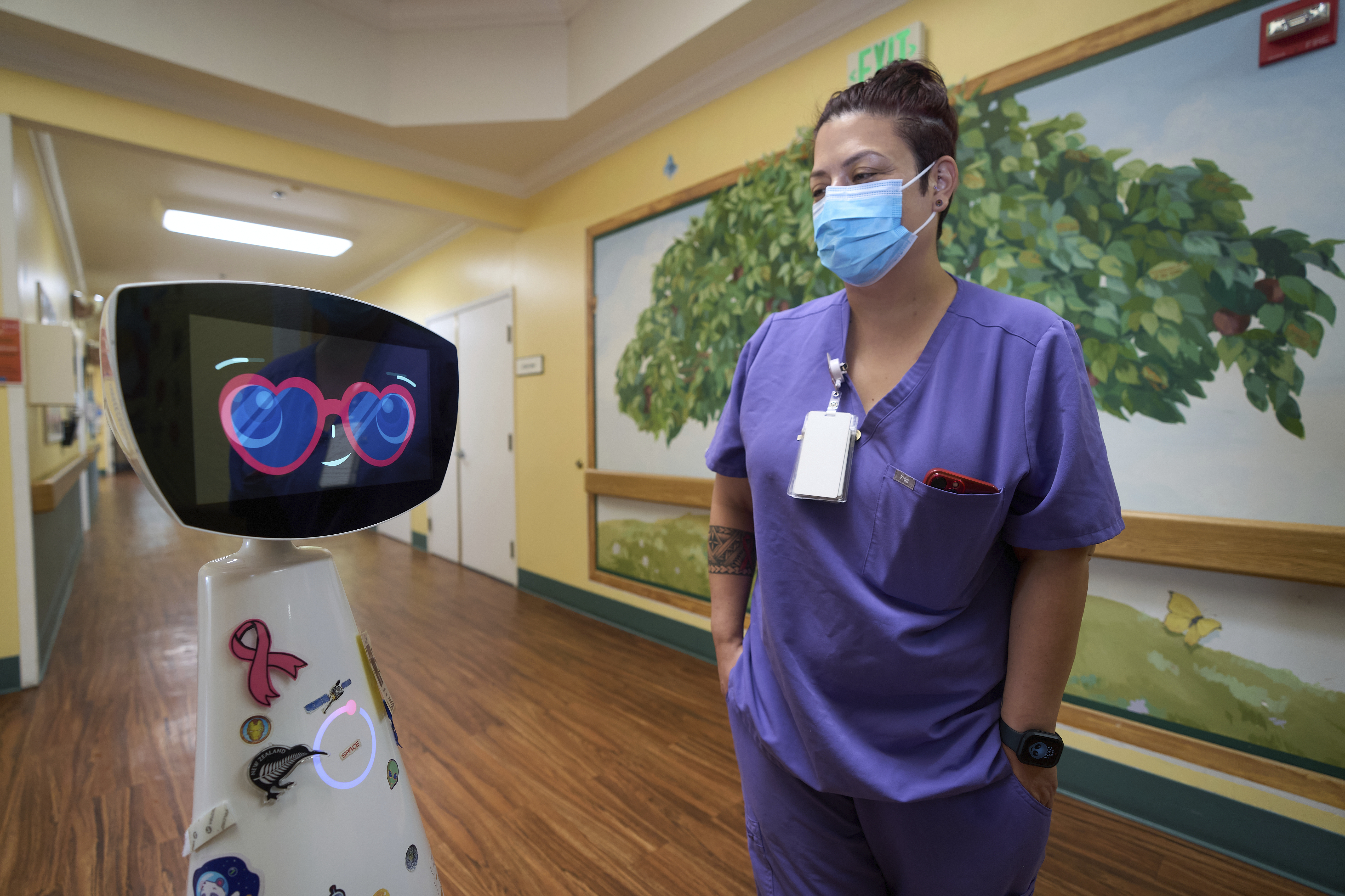 Activities Coordinator Melissa Delaney interacts with Robin the Robot as it visits patients' rooms at the HealthBridge Orange Specialty Pediatric Hospital in Orange, Calif., on Friday, Sept. 12, 2025. (Damian Dovarganes - AP)