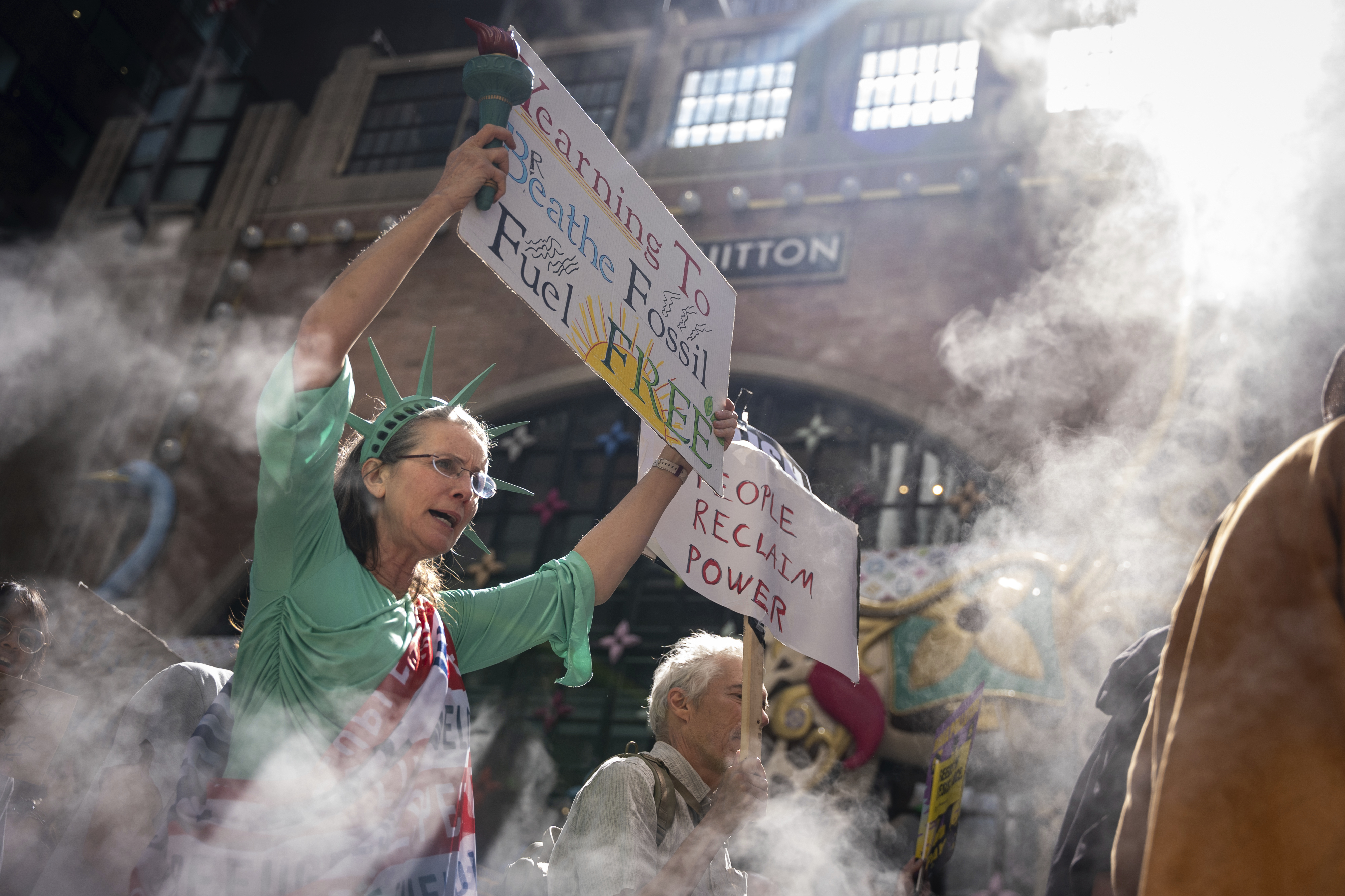 Marchers gather in worldwide protest of financial institutions ‘profiting off the climate crisis’