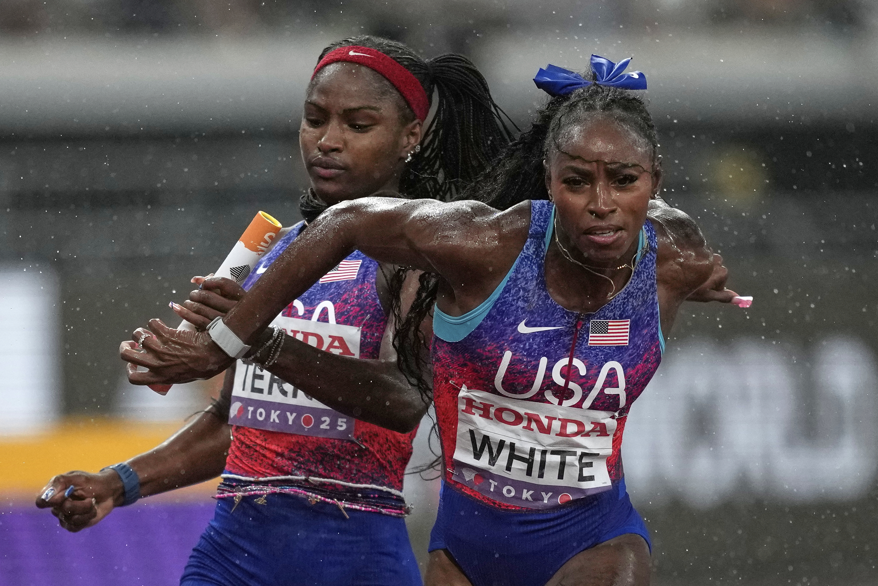 United States' Twanisha Terry passes the baton to Kayla White in the women's 4 X 100 meters relay final at the World Athletics Championships in Tokyo, Sunday, Sept. 21, 2025 (Louise Delmotte - AP)