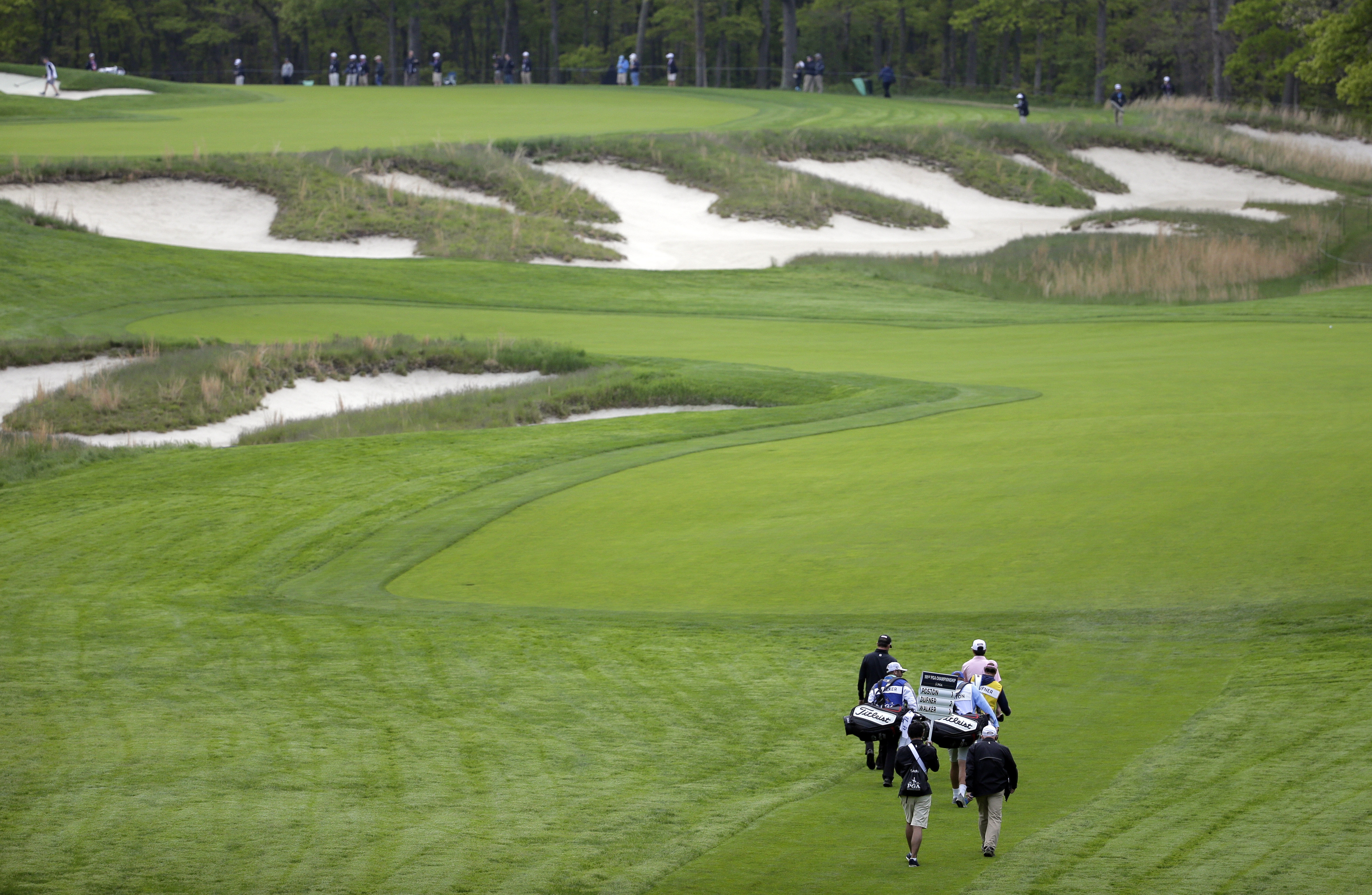 FILE - J.T. Poston, Jason Dufner and Jimmy Walker walk up the fourth fairway during the first round of the PGA Championship golf tournament, Thursday, May 16, 2019, at Bethpage Black in Farmingdale, N.Y. (Seth Wenig - AP)