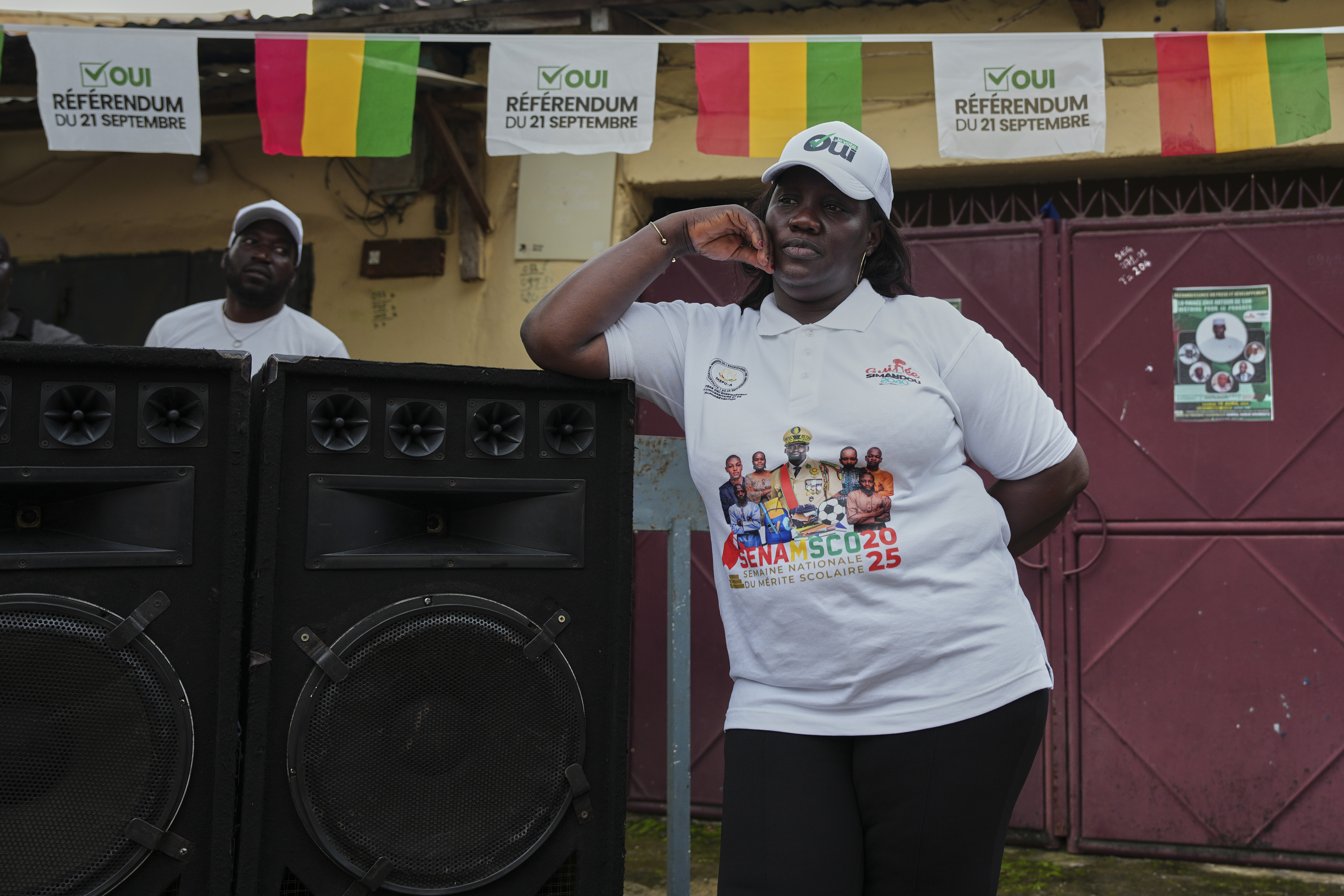 A supporter stands next to speakers during a community rally ahead of the constitutional referendum in Conakry, Guinea, Monday, Sept. 15, 2025. (Misper Apawu - AP)