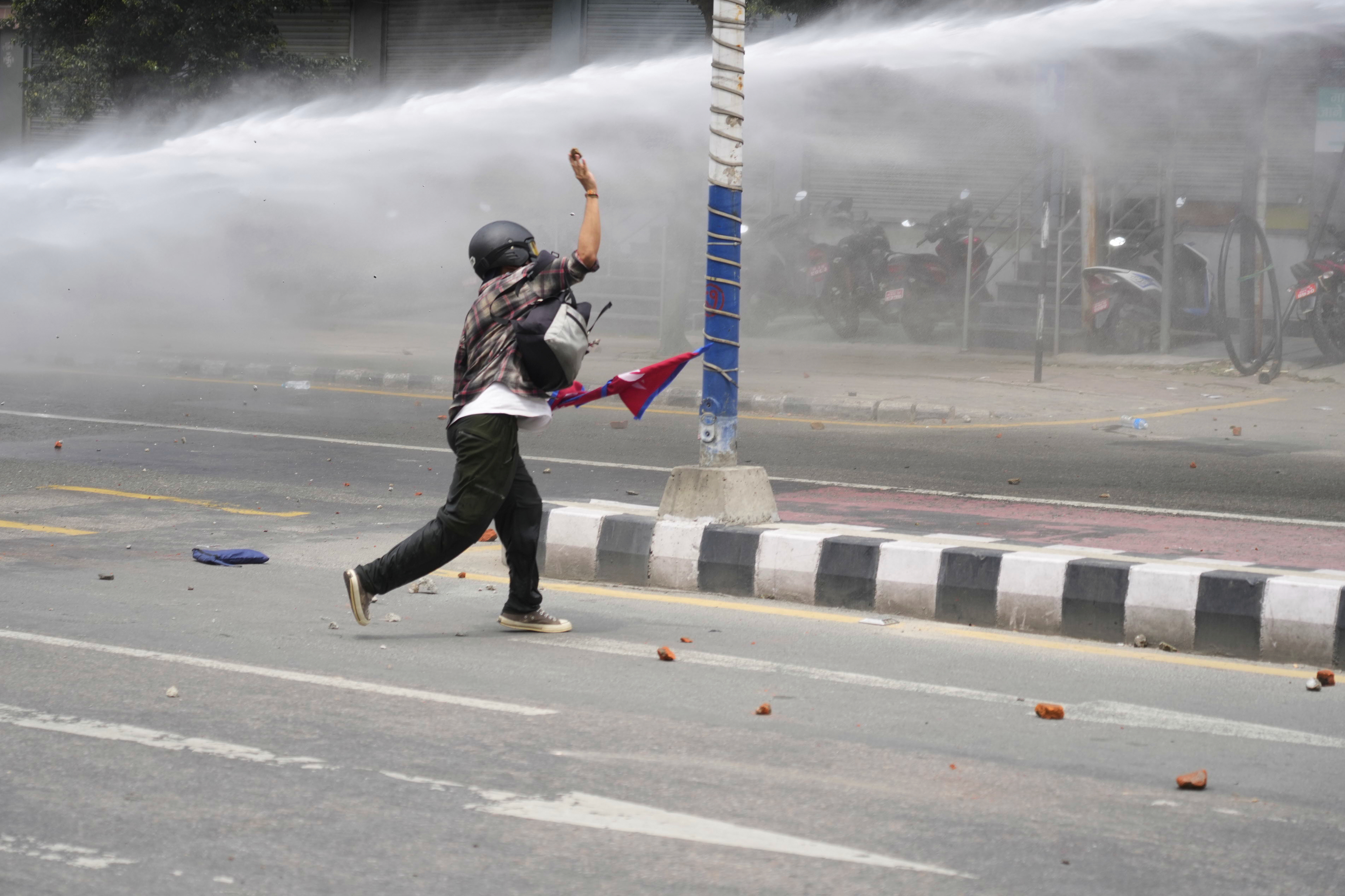 A protestor clashes with the riot police outside the Parliament building in Kathmandu, Nepal, Monday, Sept. 8, 2025. (Niranjan Shrestha - AP)
