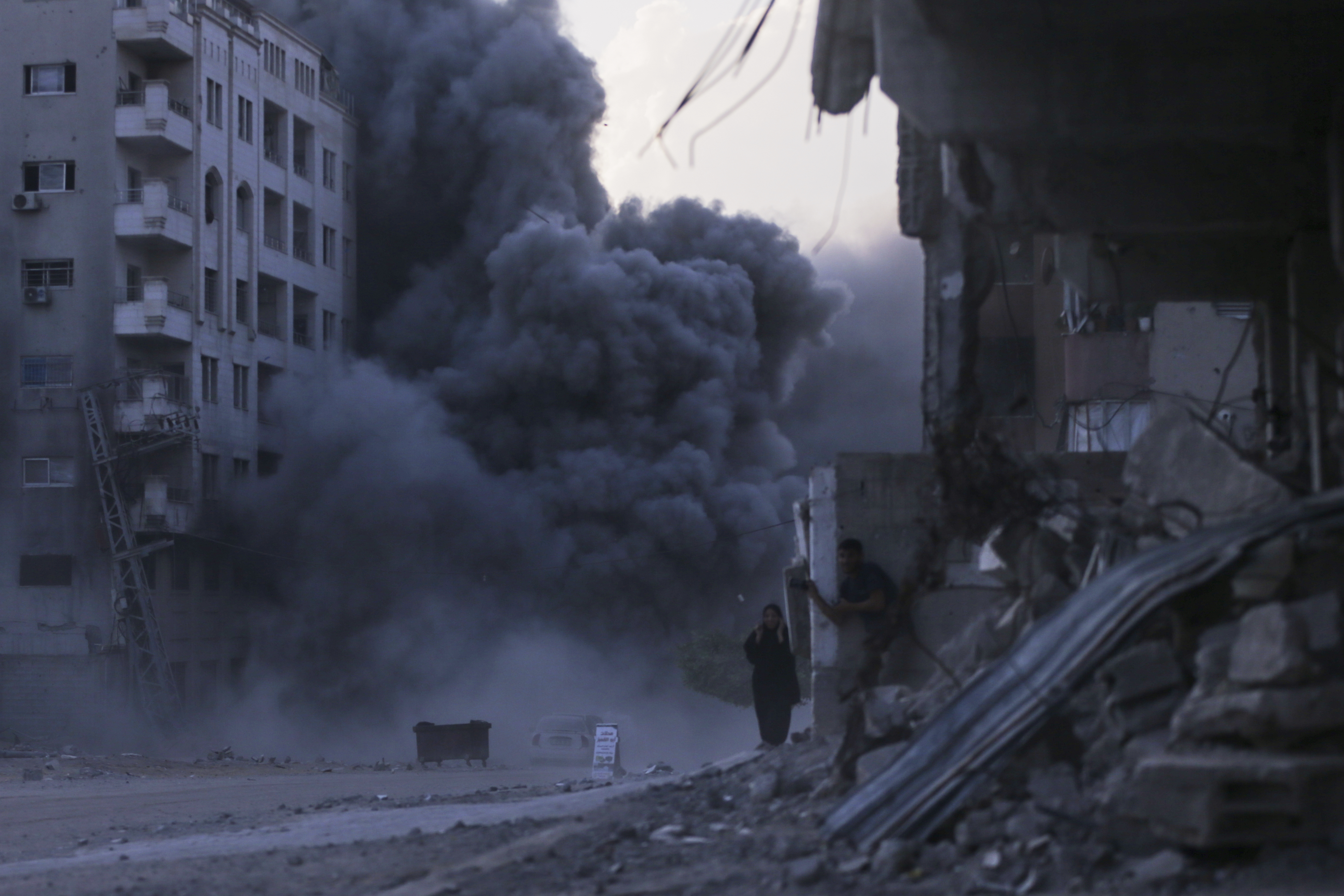 Palestinians take cover during an Israeli strike on a building in Gaza City, Sunday, Sept. 7, 2025, after the Israeli army issued a prior warning. (Yousef Al Zanoun - AP)