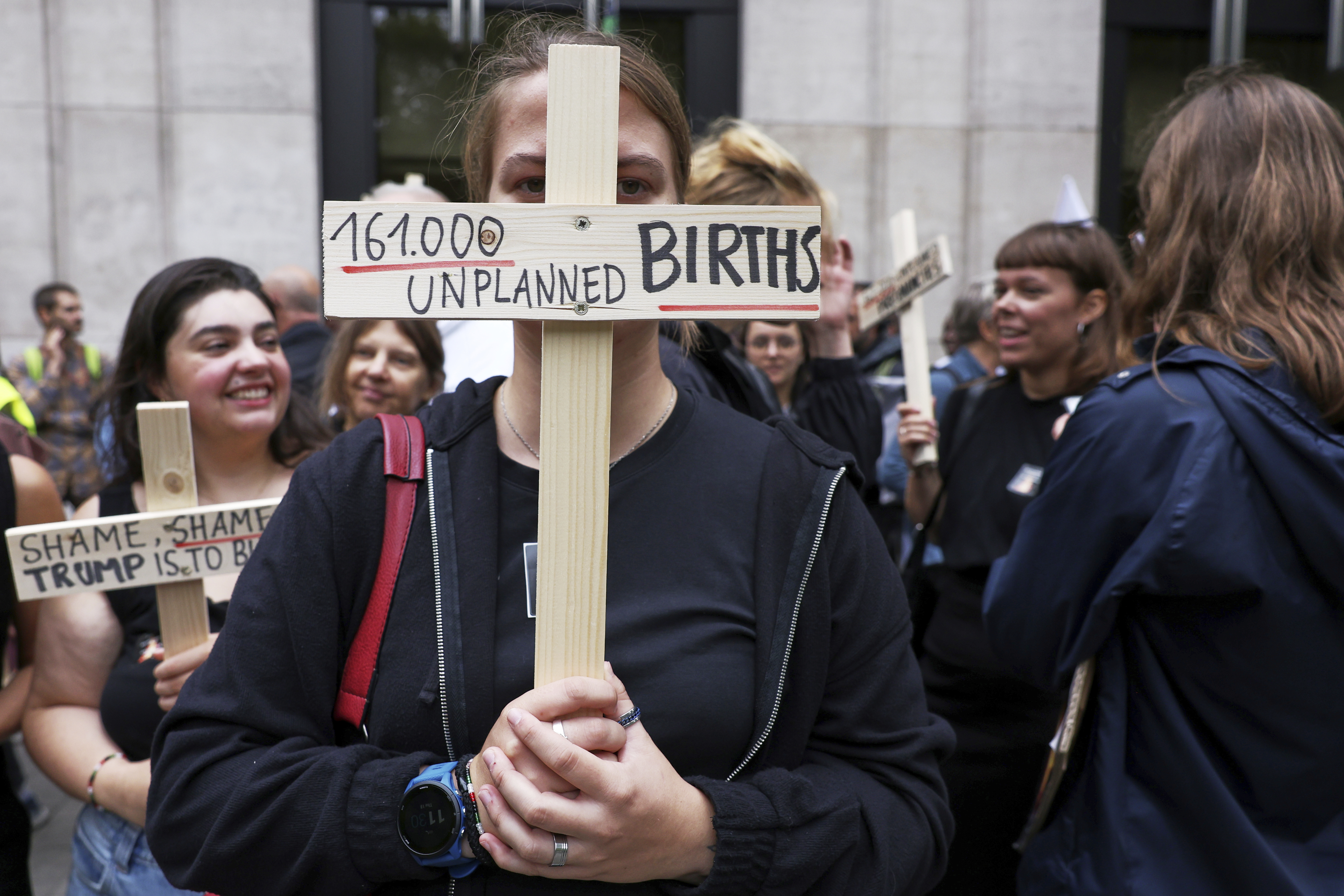 Participants from various women's rights organizations hold signs as they demonstrate regarding the destruction of family planning supplies stockpiled in Belgium, near the U.S. embassy in Brussels, Thursday, Sept. 18, 2025. (Omar Havana - AP)