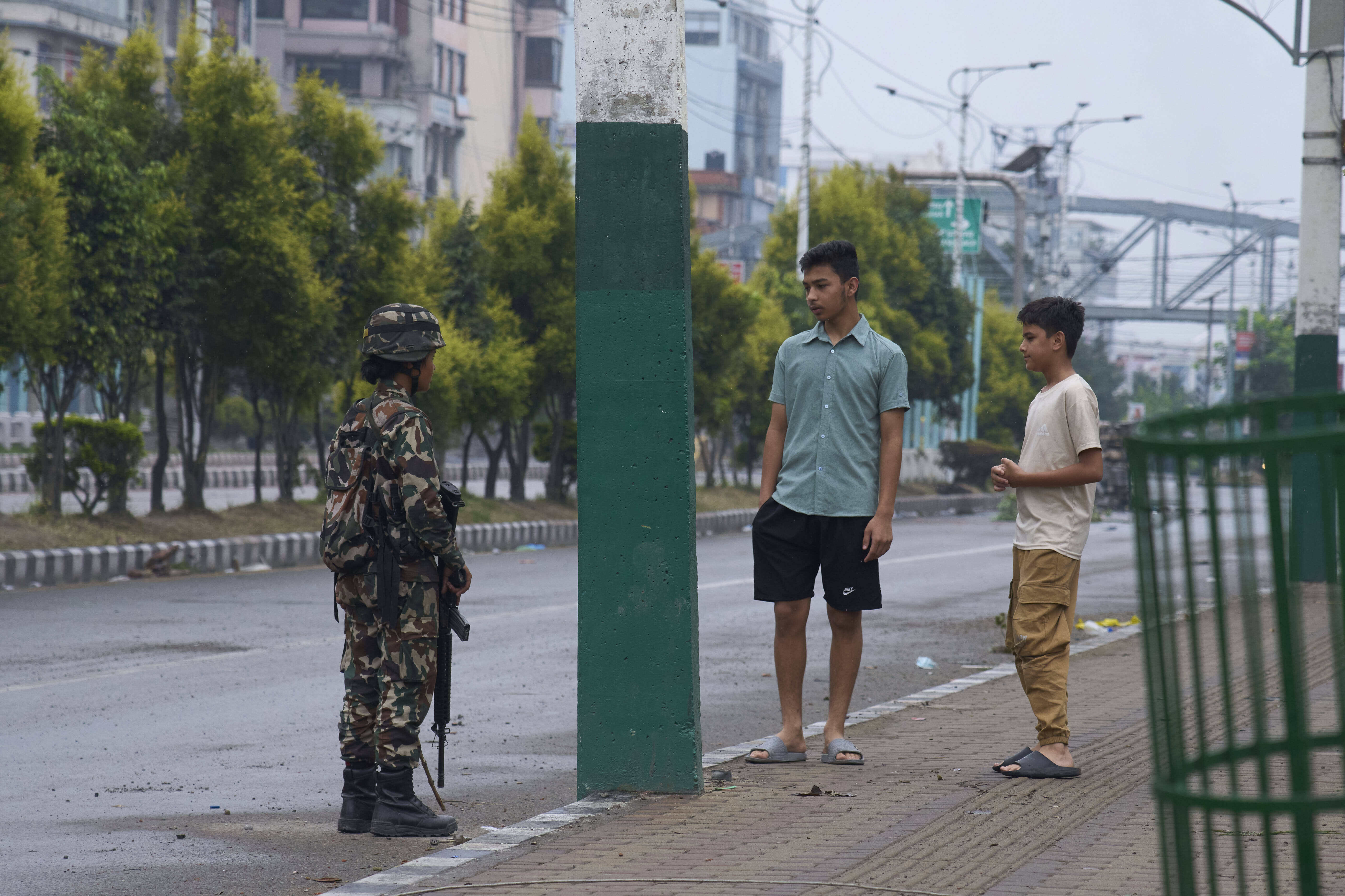 A Nepalese army person checks and question civilians at a checkpoint in Kathmandu, Nepal, Wednesday, Sept. 10, 2025. (Niranjan Shrestha - AP)