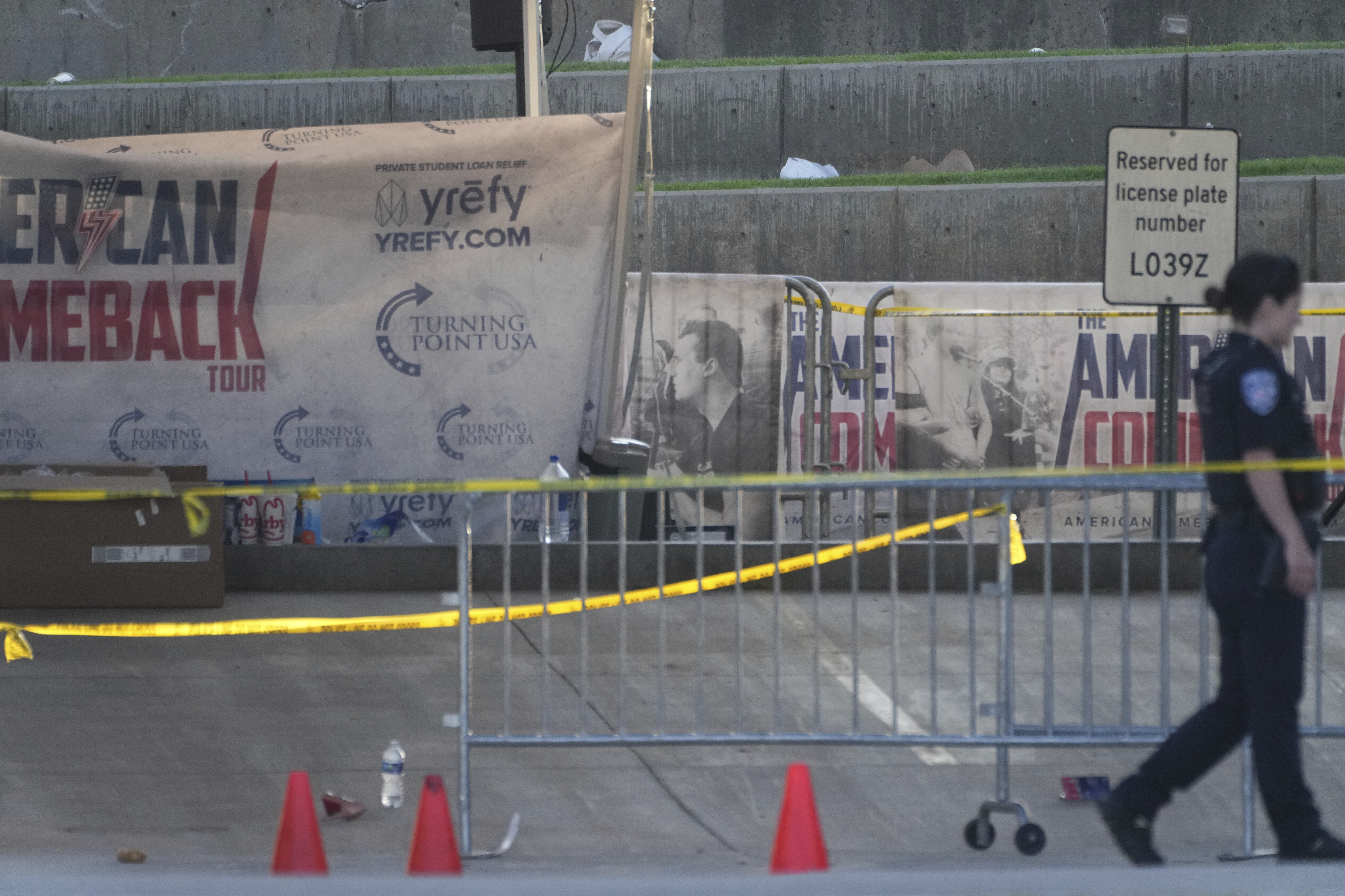 A police officer walks near the scene of the shooting of Charlie Kirk at Utah Valley University in Orem, Utah, Thursday, Sept. 11, 2025. (Lindsey Wasson - AP)