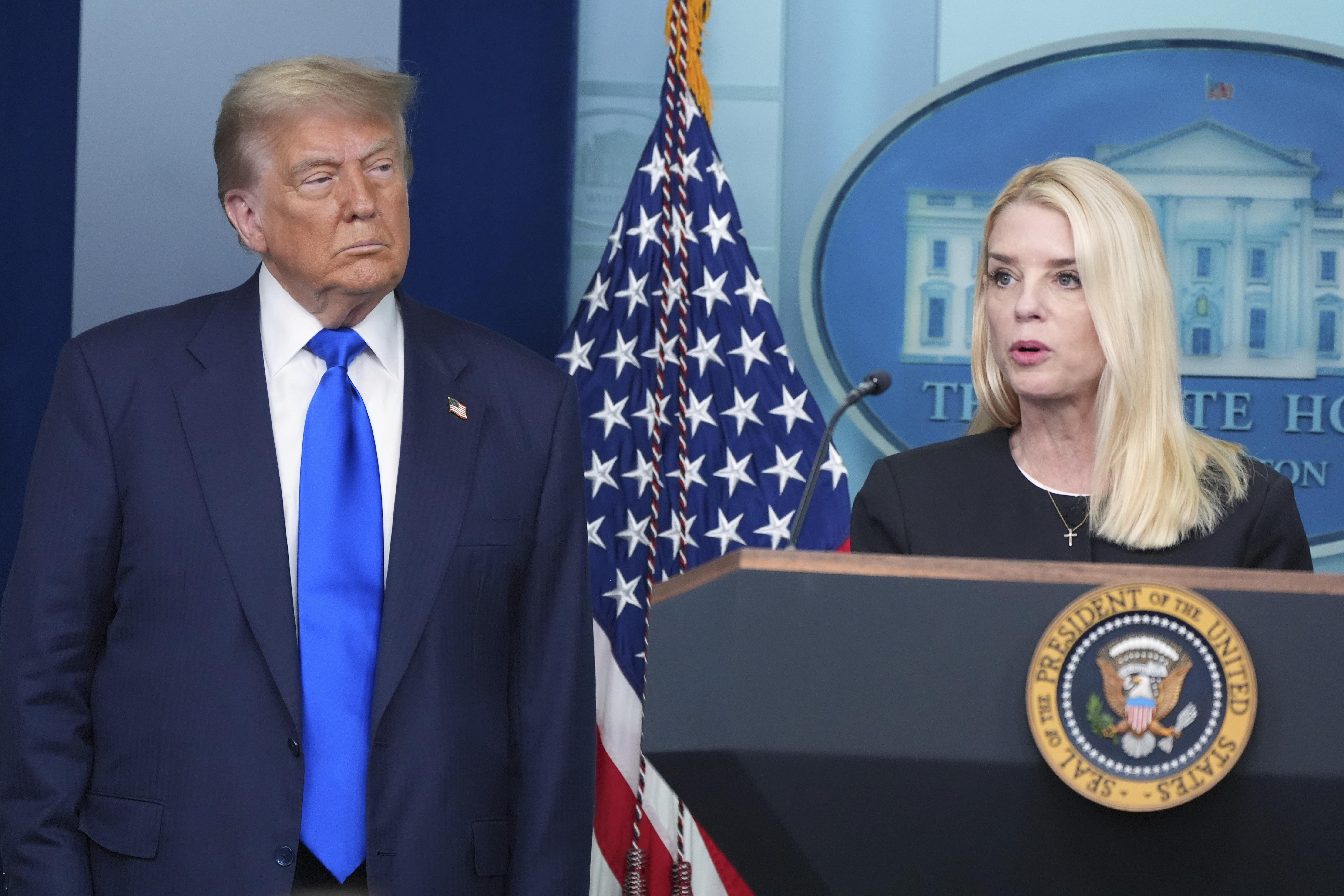 FILE - Attorney General Pam Bondi speaks to reporters as President Donald Trump listens, Friday, June 27, 2025, in the briefing room of the White House in Washington. (Jacquelyn Martin - AP)