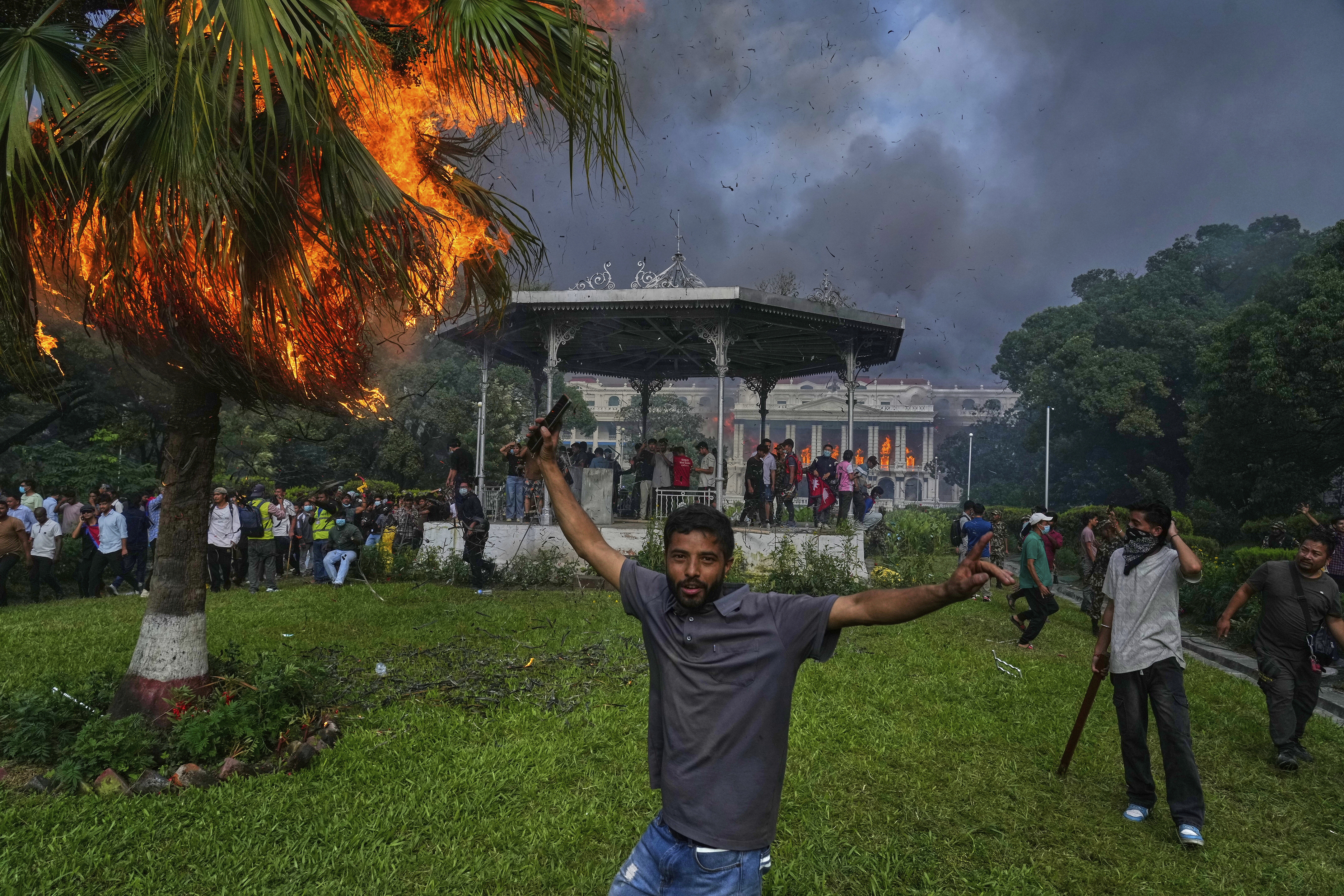 Protesters celebrate at the Singha Durbar, the seat of Nepal's government's various ministries and offices, after it was set on fire during a protest against a social media ban and corruption in Kathmandu, Nepal, Tuesday, Sept. 9, 2025. (Niranjan Shrestha - AP)