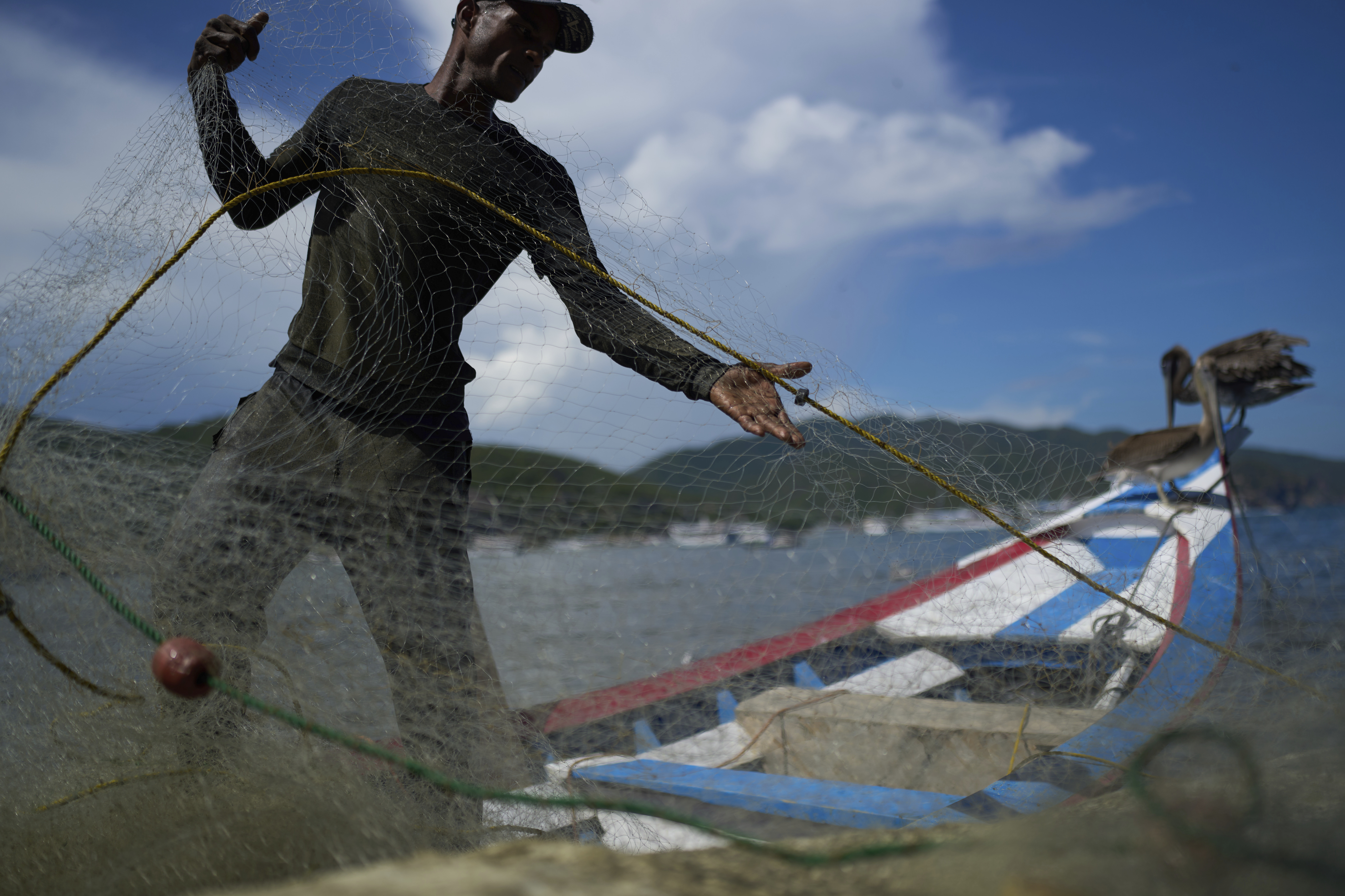 A fisherman prepares his net in the fishing community of El Morro de Puerto Santo, on Venezuela's Paria Peninsula, Sunday, Sept. 14, 2025. (Ariana Cubillos - AP)