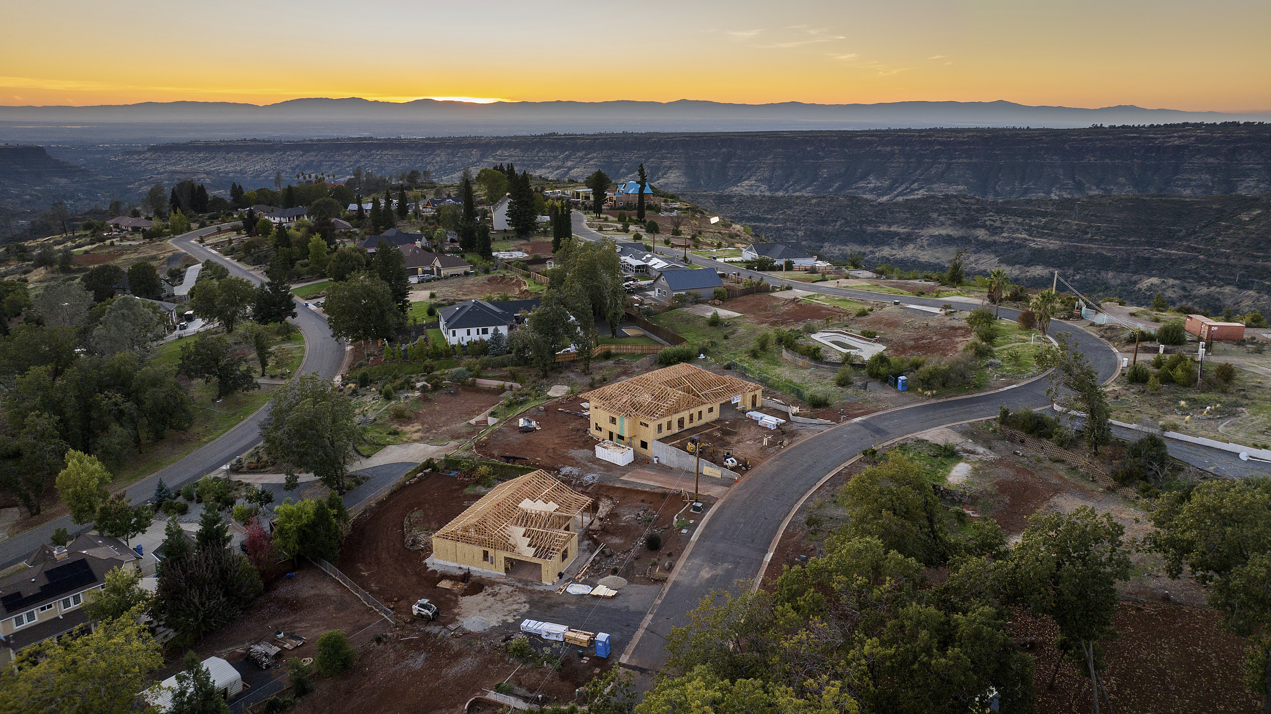 FILE - The sun sets over Valley Ridge Drive, Oct. 26, 2023, in Paradise, Calif. (Noah Berger - FR34727 AP)