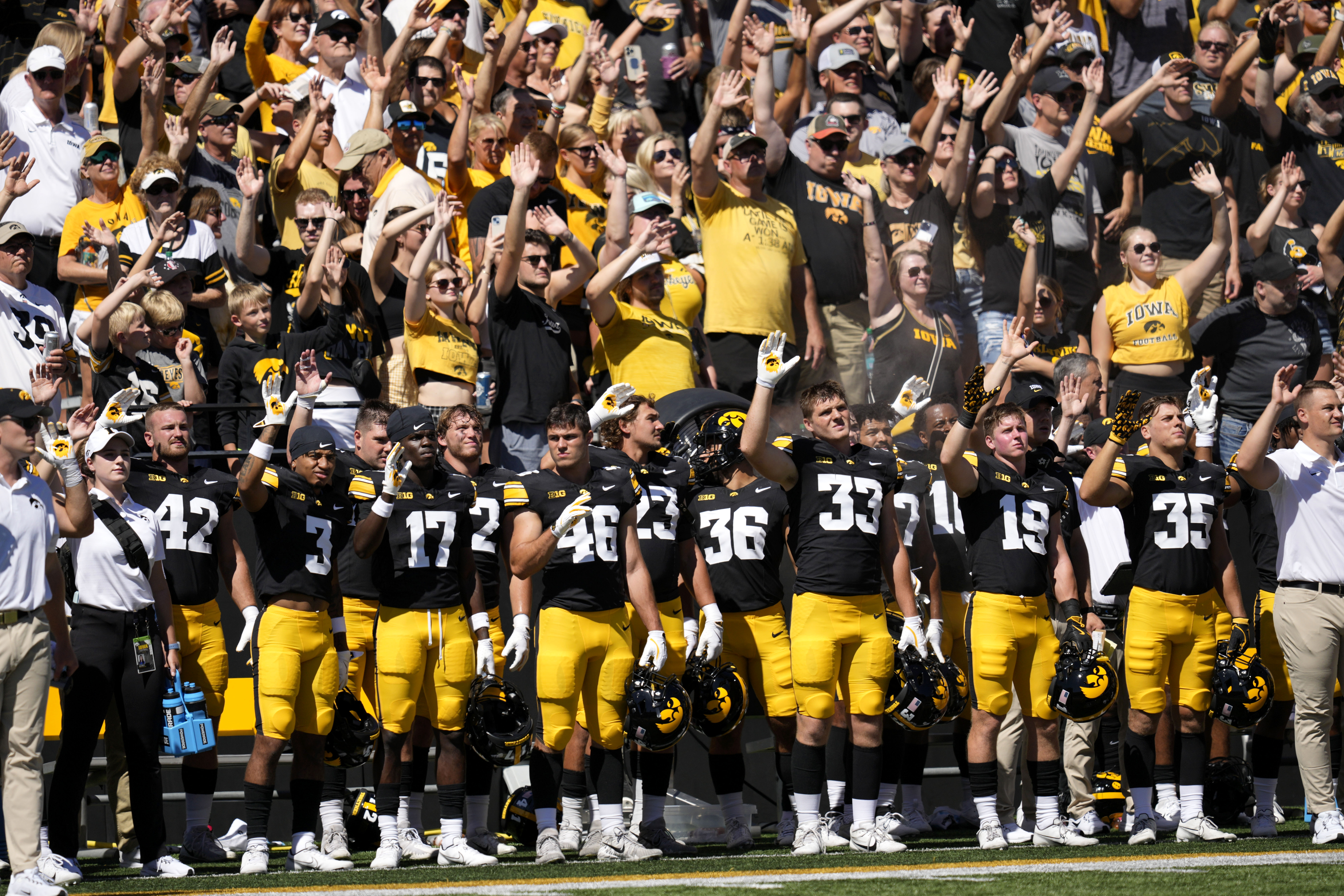 FILE - Iowa players wave to children in the University of Iowa Stead Family Children's Hospital at the end of the first quarter of an NCAA college football game against Illinois State, Aug. 31, 2024, in Iowa City, Iowa. (Charlie Neibergall - AP)