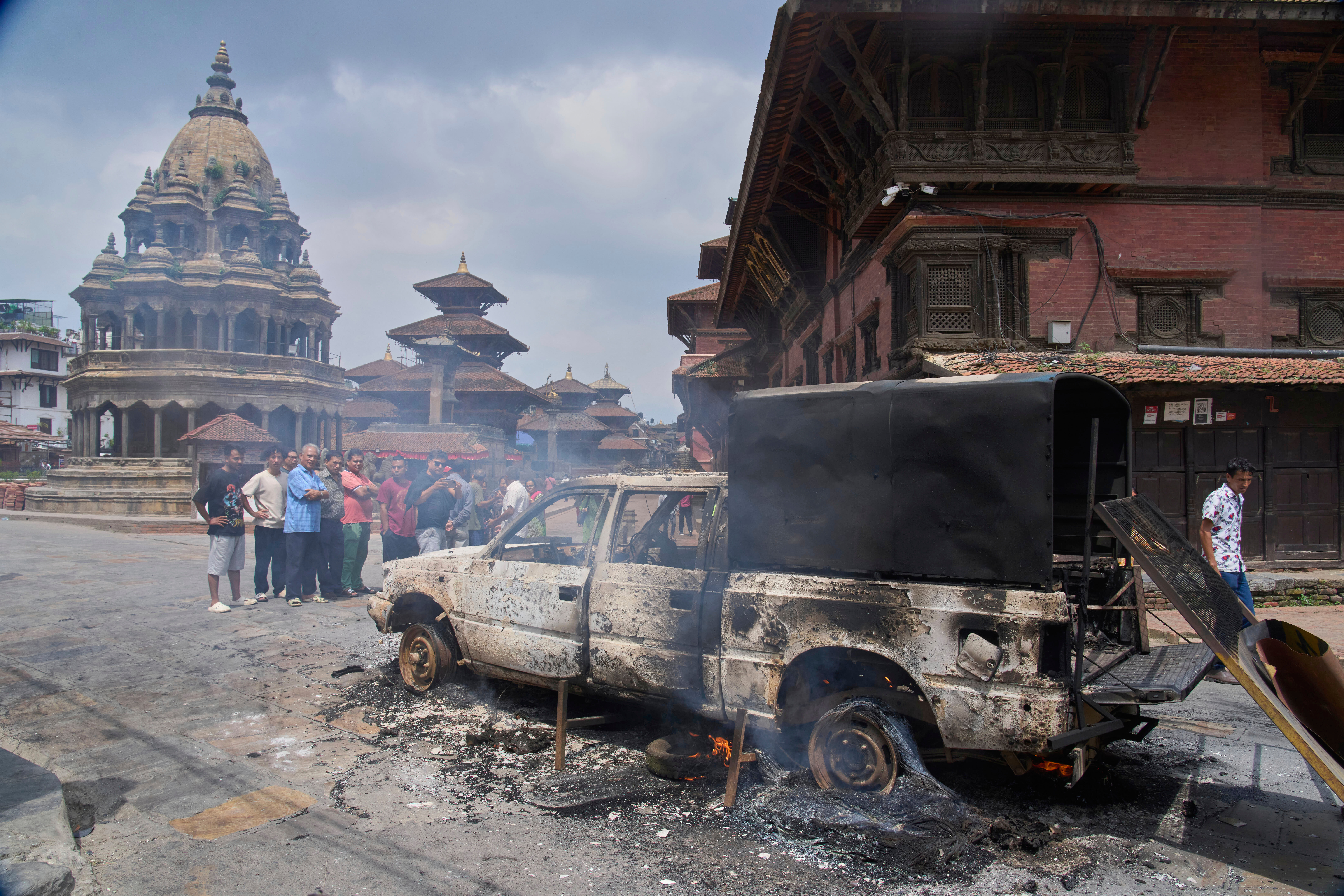 People look at a burnt police vehicle during protests against social media ban and corruption in Kathmandu, Nepal, Tuesday, Sept. 9, 2025. (Niranjan Shrestha - AP)