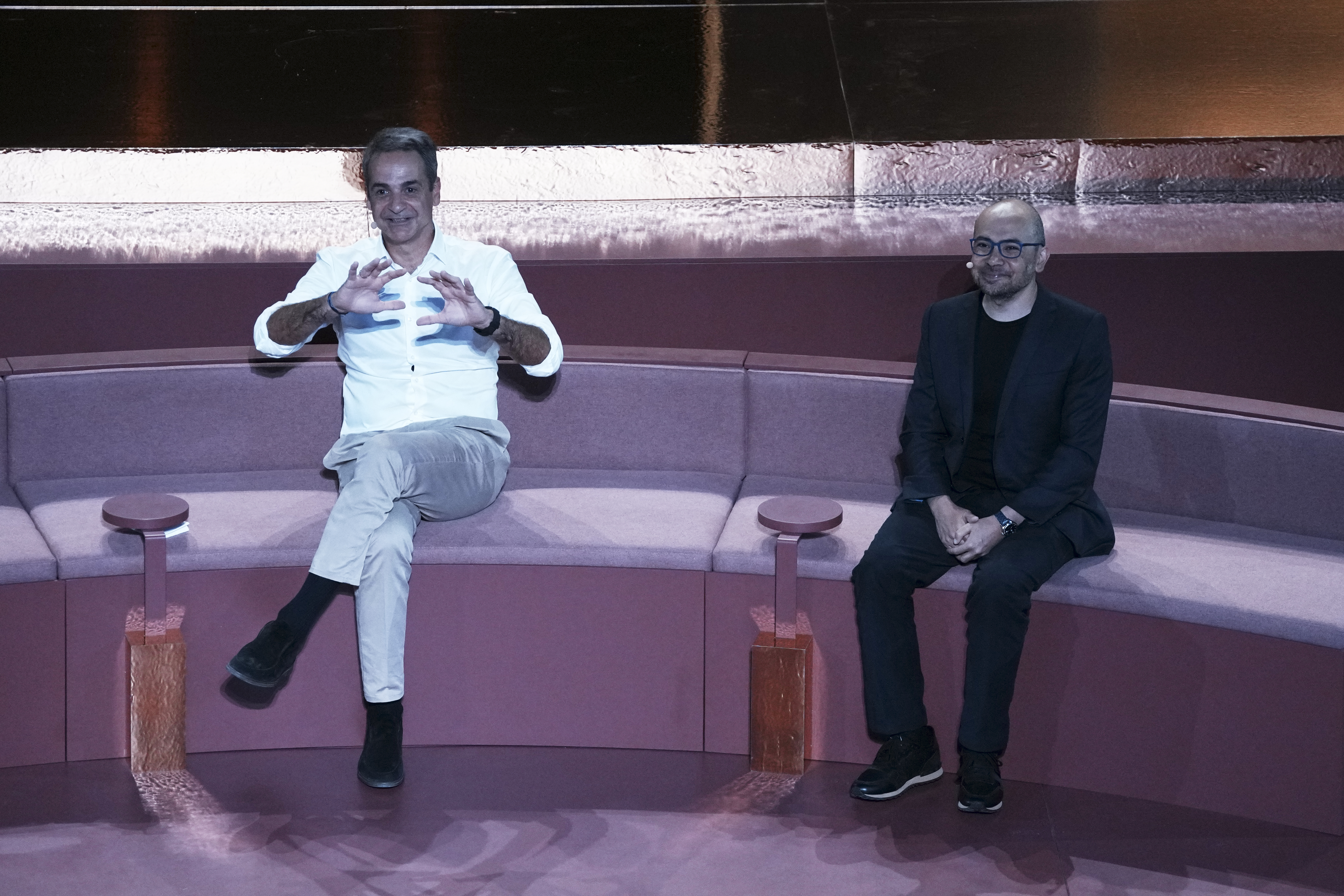 Greece's Prime Minister Kyriakos Mitsotakis, left, and Demis Hassabis, CEO of Google's artificial intelligence research company DeepMind discuss the future of AI, ethics and democracy during an event at the Odeon of Herodes Atticus, in Athens, Greece, Friday, Sept. 12, 2025. (Thanassis Stavrakis - AP)