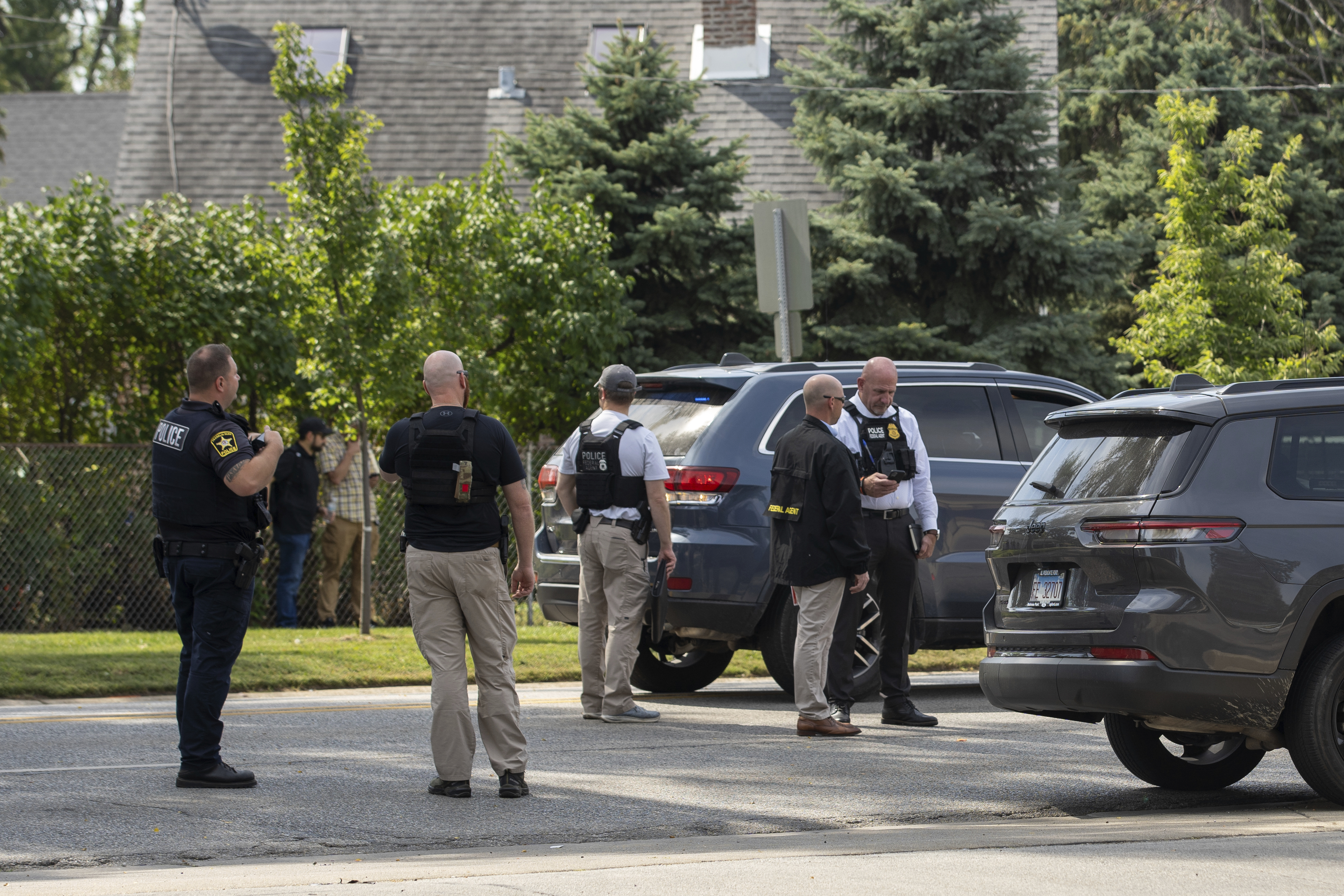 Law enforcement personnel investigate after the Department of Homeland Security said an Immigration and Customs Enforcement agent fatally shot a man in the Franklin Park suburb of Chicago on Friday, Sept. 12, 2025. (Candace Dane Chambers - Chicago Sun-Times)