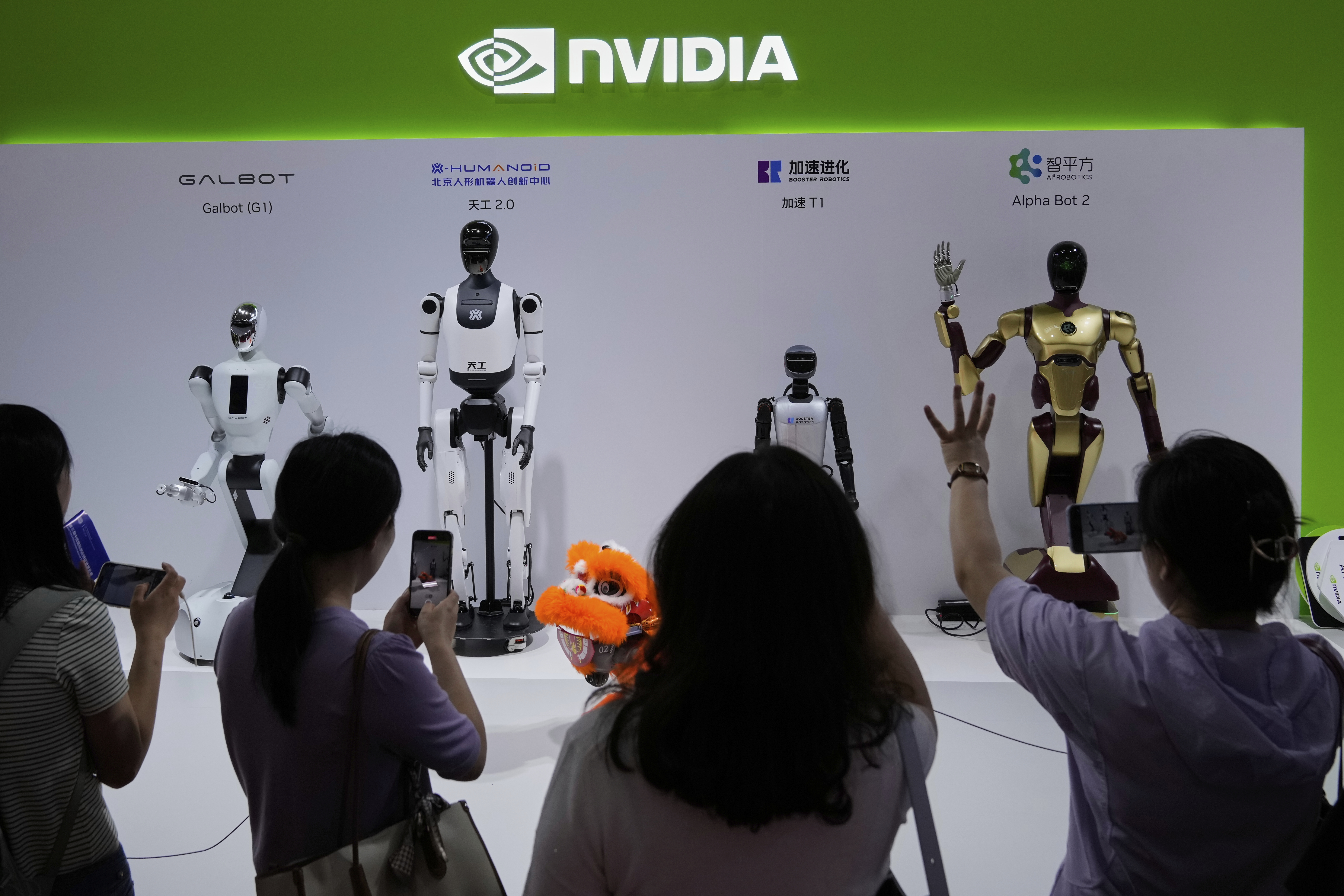 FILE - Visitors give commands to a robot at Nvidia's booth during the 3rd China International Supply Chain Expo at the China International Exhibition Center, in Beijing, July 18, 2025. (Mahesh Kumar A. - AP)