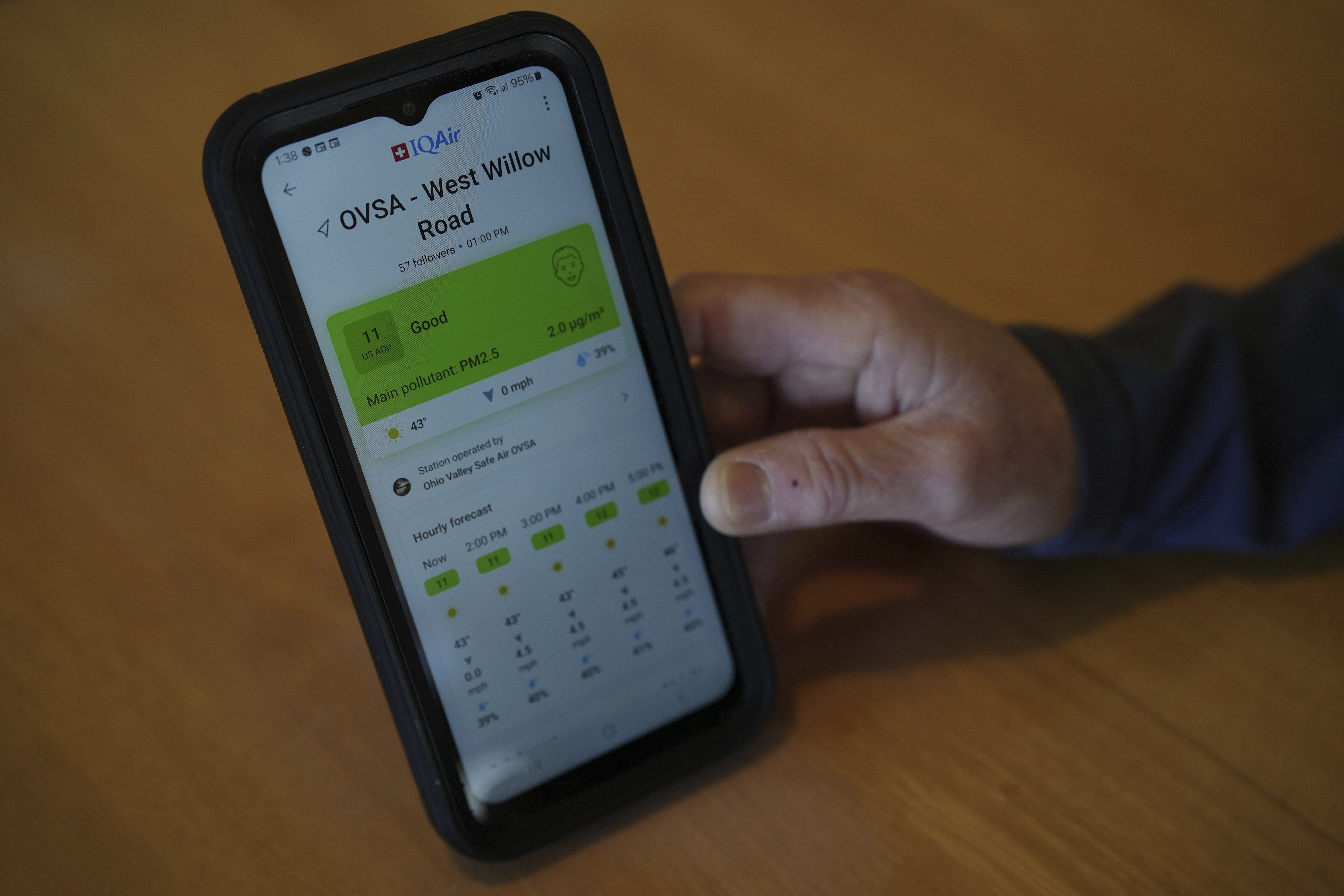 FILE - Mary Hess displays air quality data on the IQAir app on her phone, April 8, 2025, in Dale, Ind. (Joshua A. Bickel - AP)