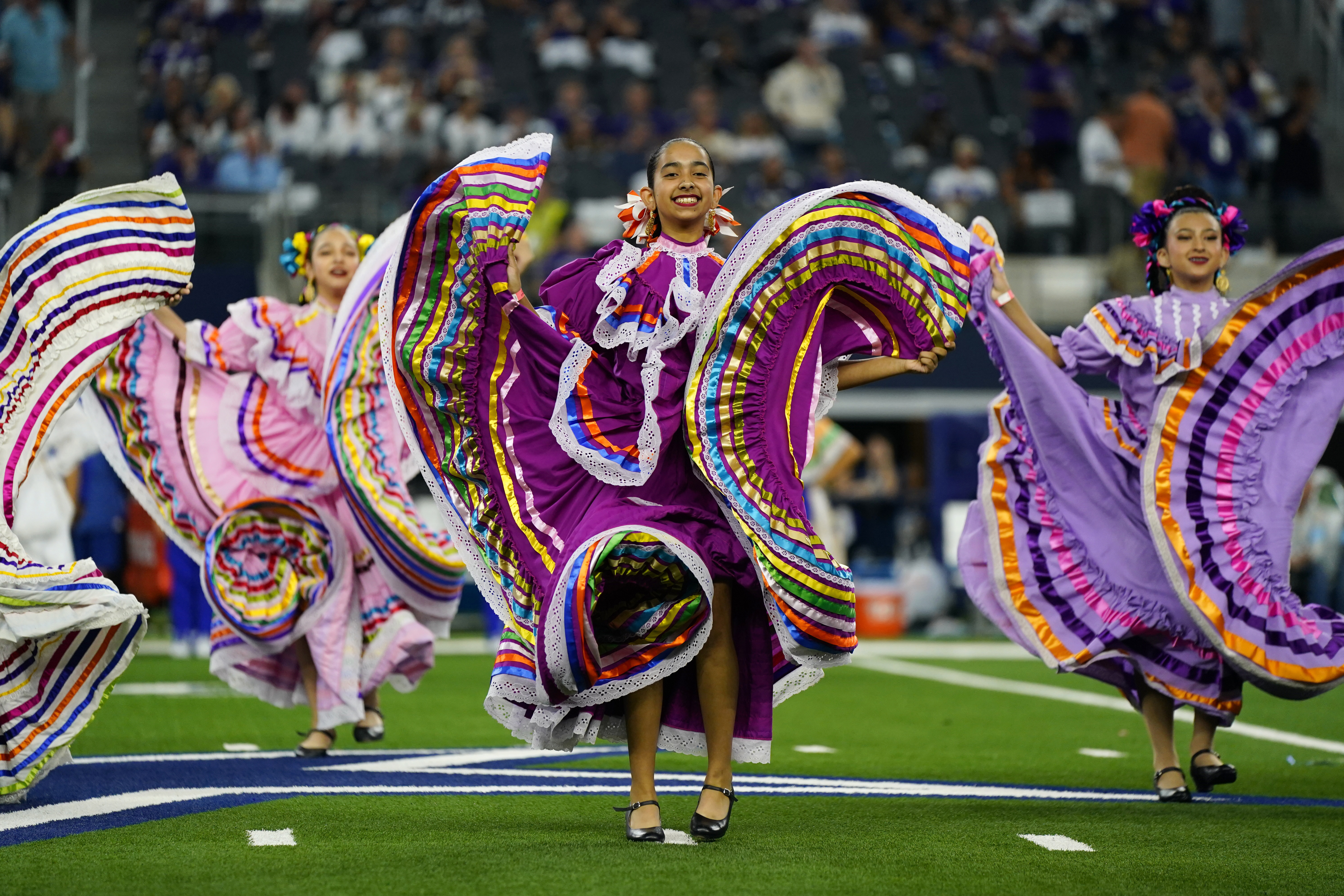 A folklorico dance group performs at haltfime of an NFL football game between the Baltimore Ravens and Dallas Cowboys in Arlington, Texas, Sunday, Sept. 22, 2024. (Jeffrey McWhorter - FR170451 AP)