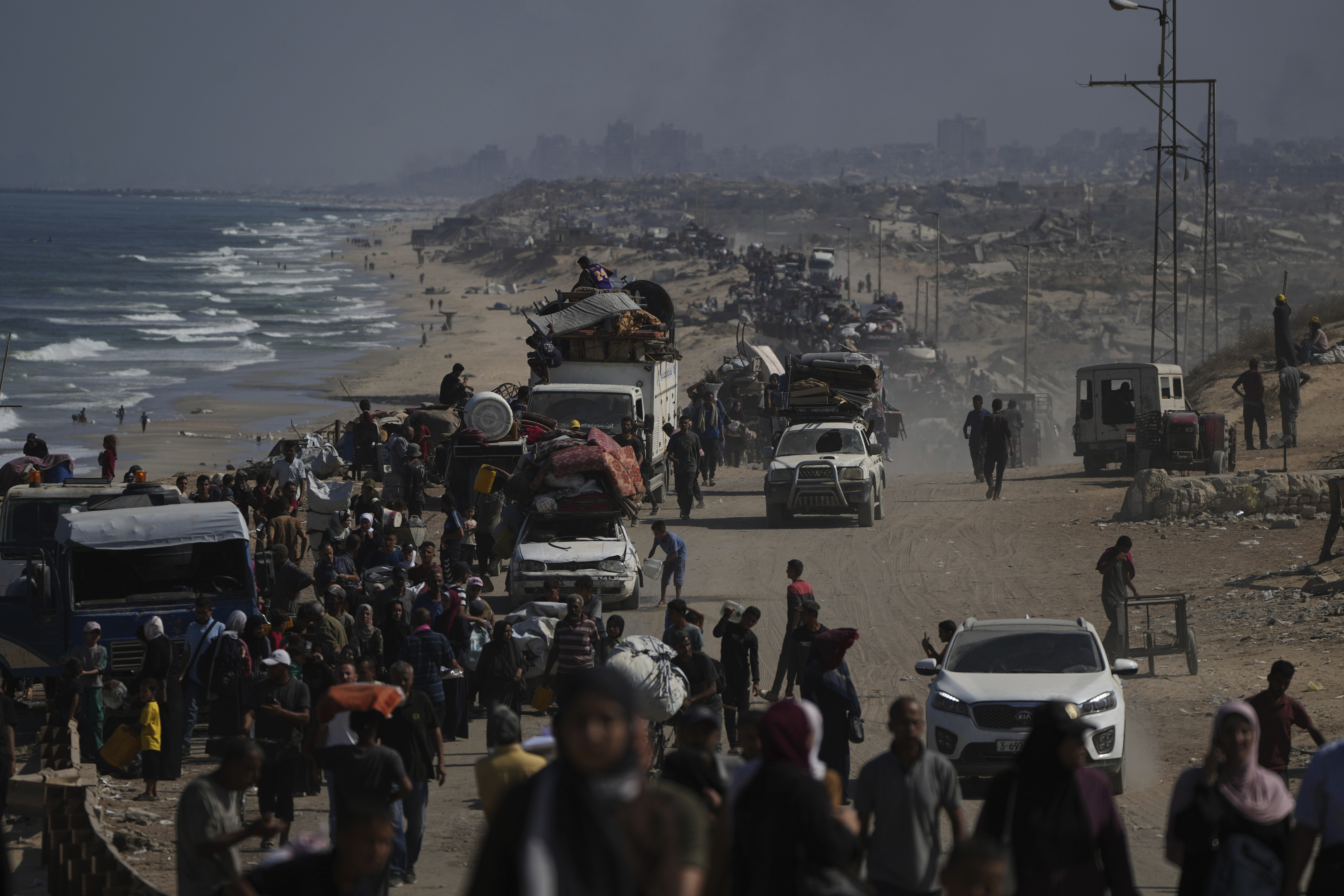 Displaced Palestinians flee Gaza City by foot and vehicles, carrying their belongings along the coastal road toward southern Gaza, Wednesday, Sept. 17, 2025. (Abdel Kareem Hana - AP)