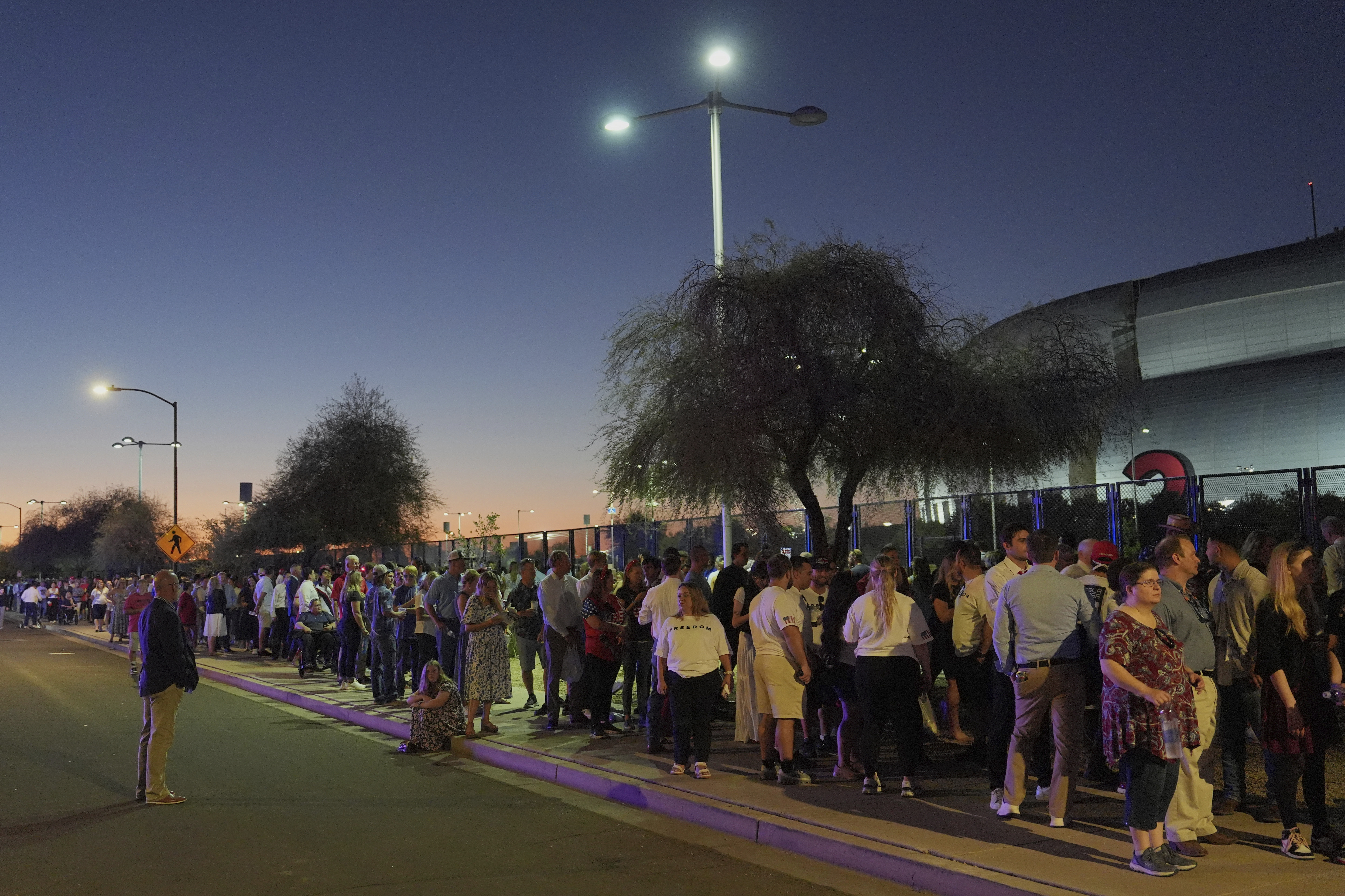 People wait in line before a memorial for conservative activist Charlie Kirk Sunday, Sept. 21, 2025, at State Farm Stadium in Glendale, Ariz. (Jae C. Hong - AP)