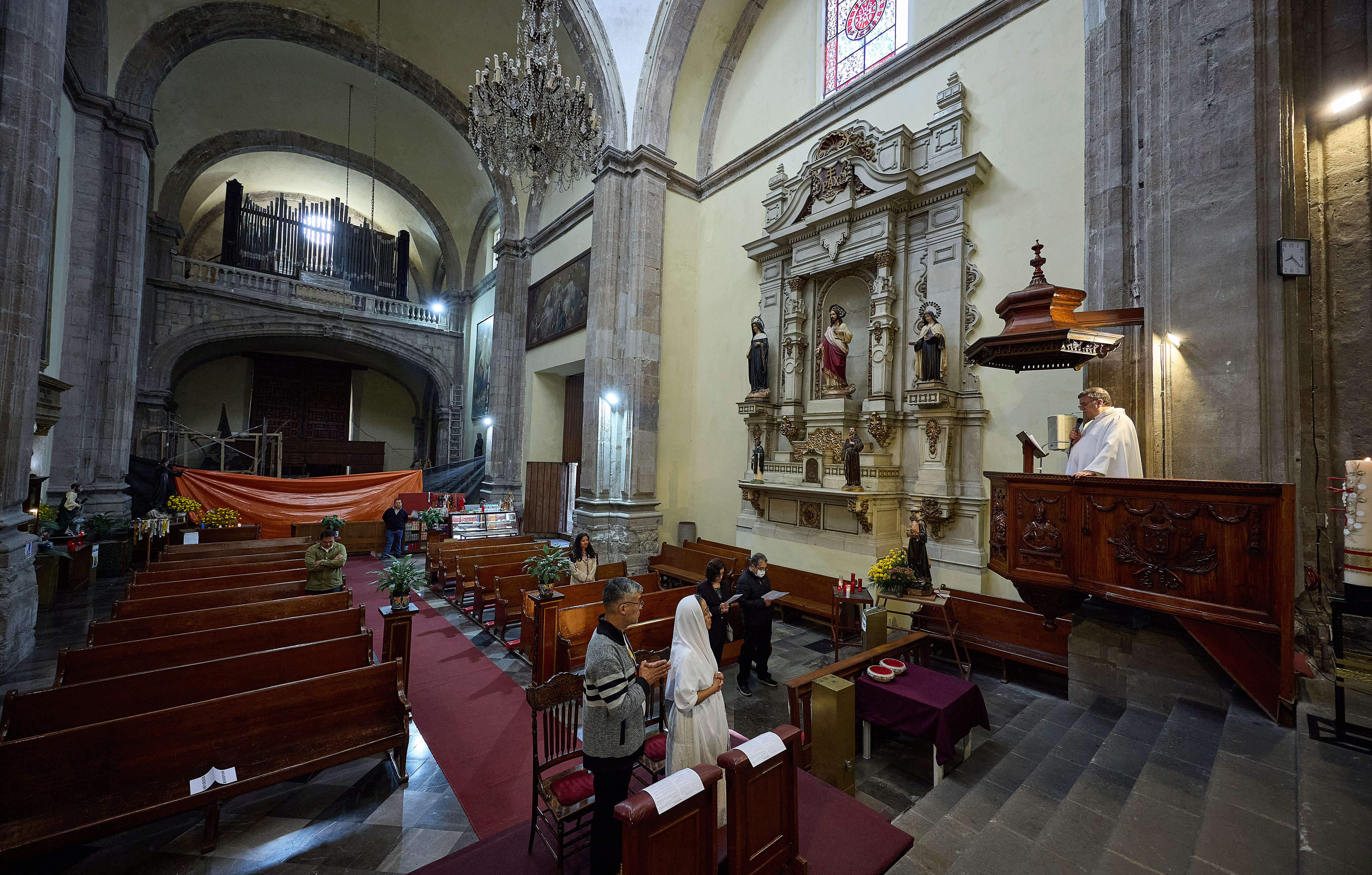 Vinicio Cruz and Carmen Chavez get married during a ceremony by Father Juan Carlos Guerrero inside San Juan de Dios church in Mexico City, Friday, Sept. 19, 2025. The church withstood the 8.0 earthquake of 1985, however, its structure was severely damaged in 2017 and it was forced to shut down and reopened in late 2024 after most of its restoration was completed. (Ginnette Riquelme - AP)