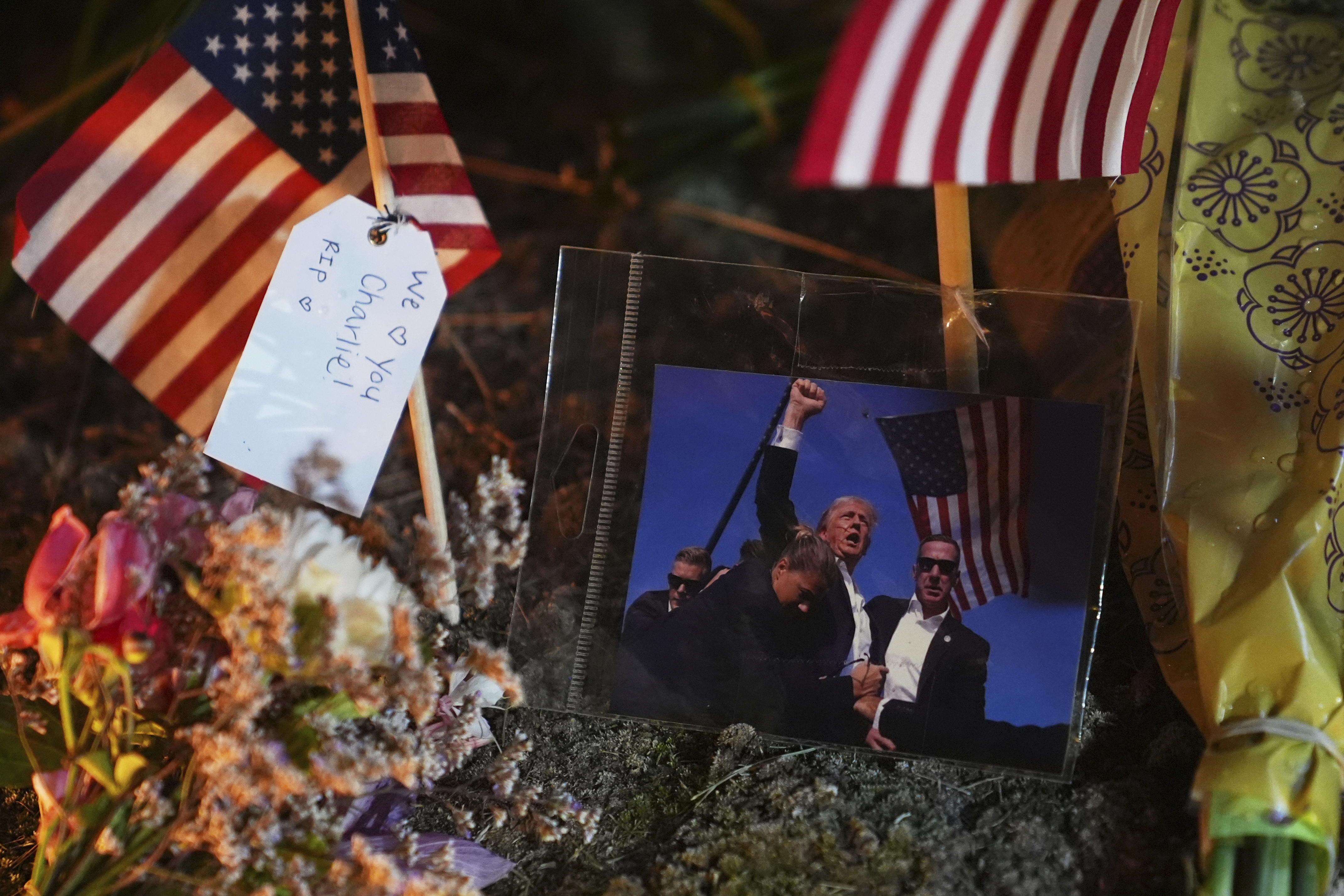 A photo of President Donald Trump is seen at a growing memorial for Charlie Kirk outside Timpanogos Regional Hospital after Kirk was shot and killed Wednesday, Sept. 10, 2025, in Orem, Utah. (Lindsey Wasson - AP)