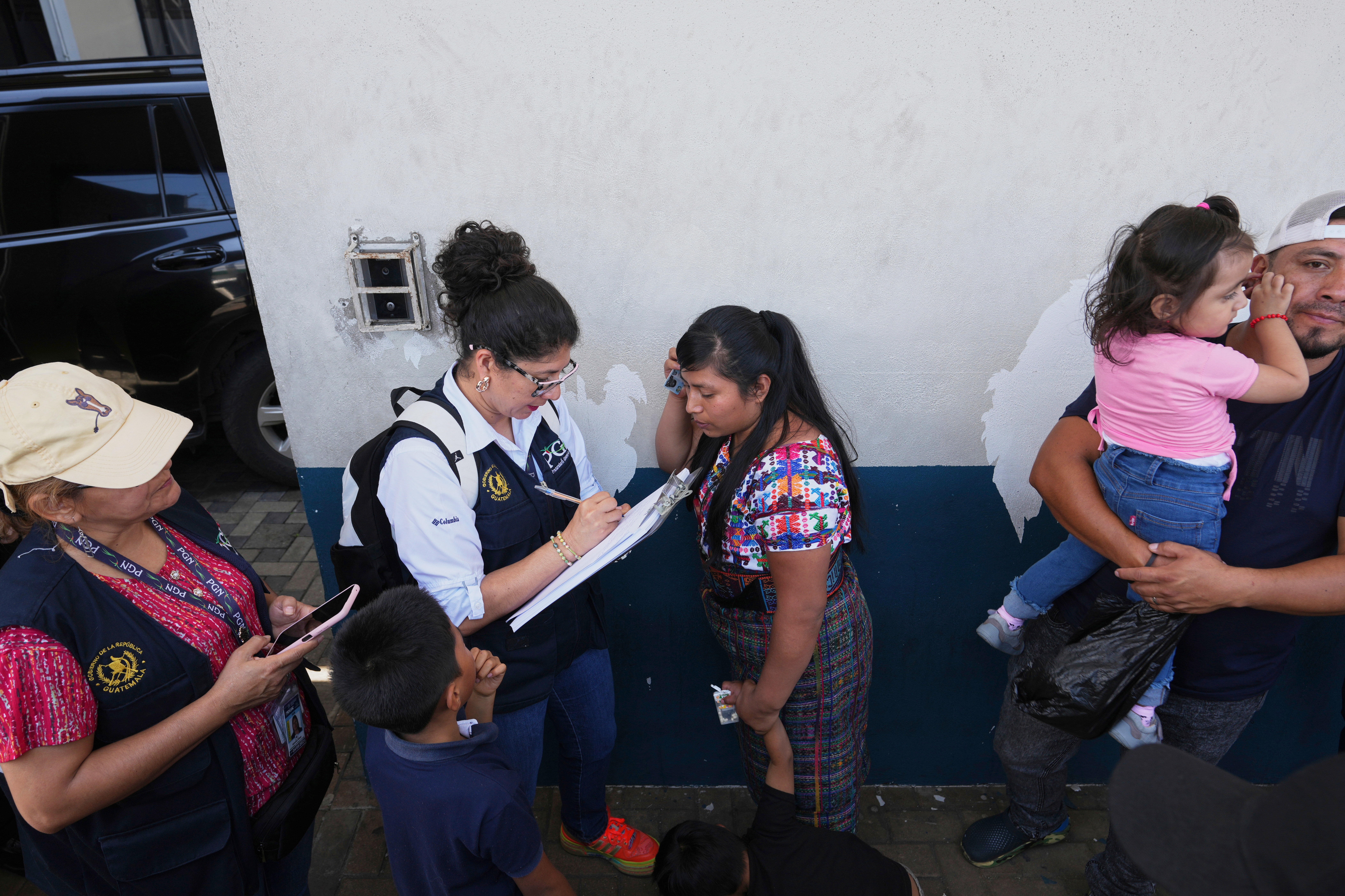 FILE - Relatives of unaccompanied minors deported from the United States await updates outside La Aurora International Airport, in Guatemala City, Aug. 31, 2025. (Moises Castillo - AP)