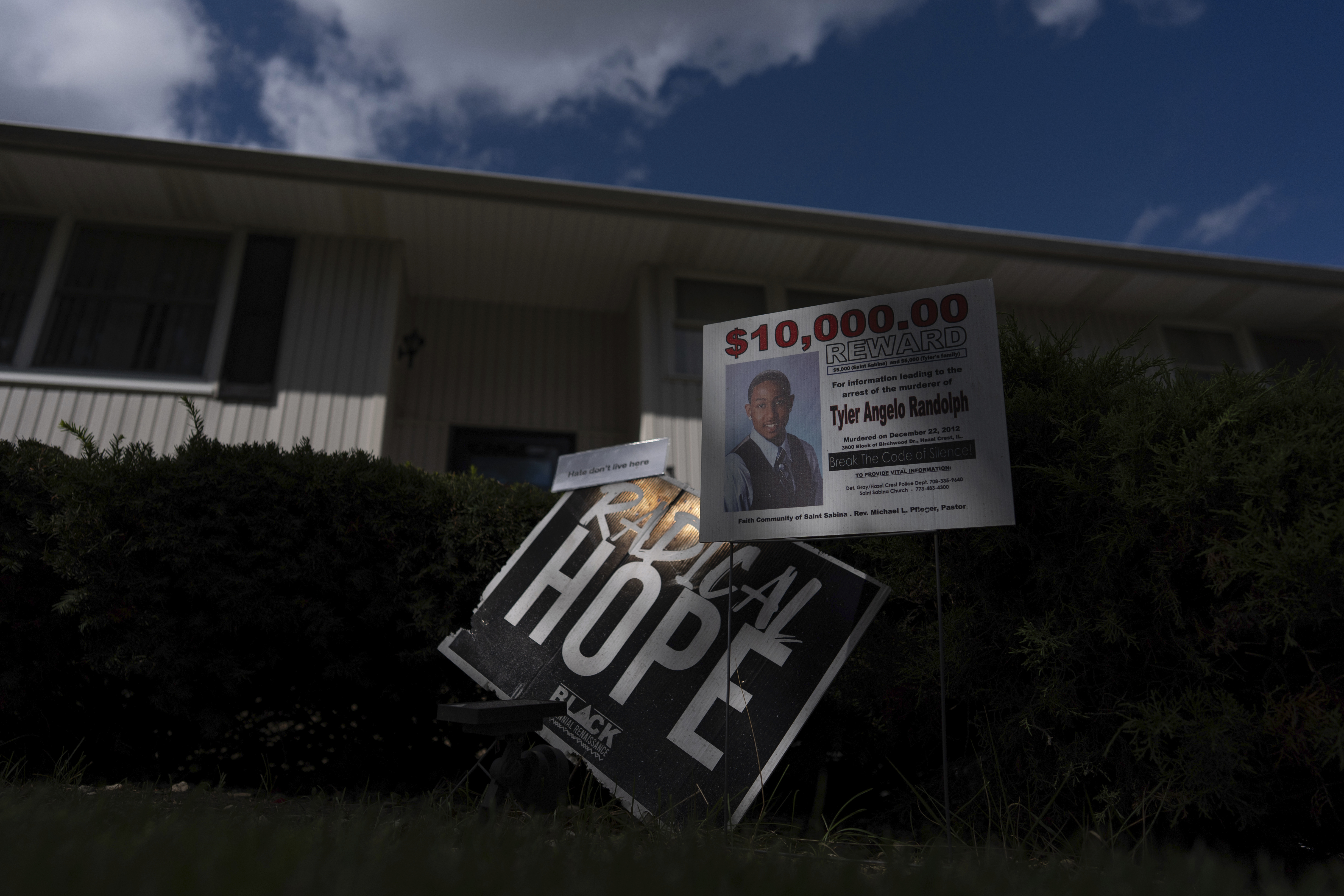 Signs are posted in front of Delphine Cherry's home Friday, Sept. 5, 2025, in Hazel Crest, Ill. Cherry lost two children, Tyler Randolph, and Tyesa Abney, to shootings in and near Chicago. (Carolyn Kaster - AP)