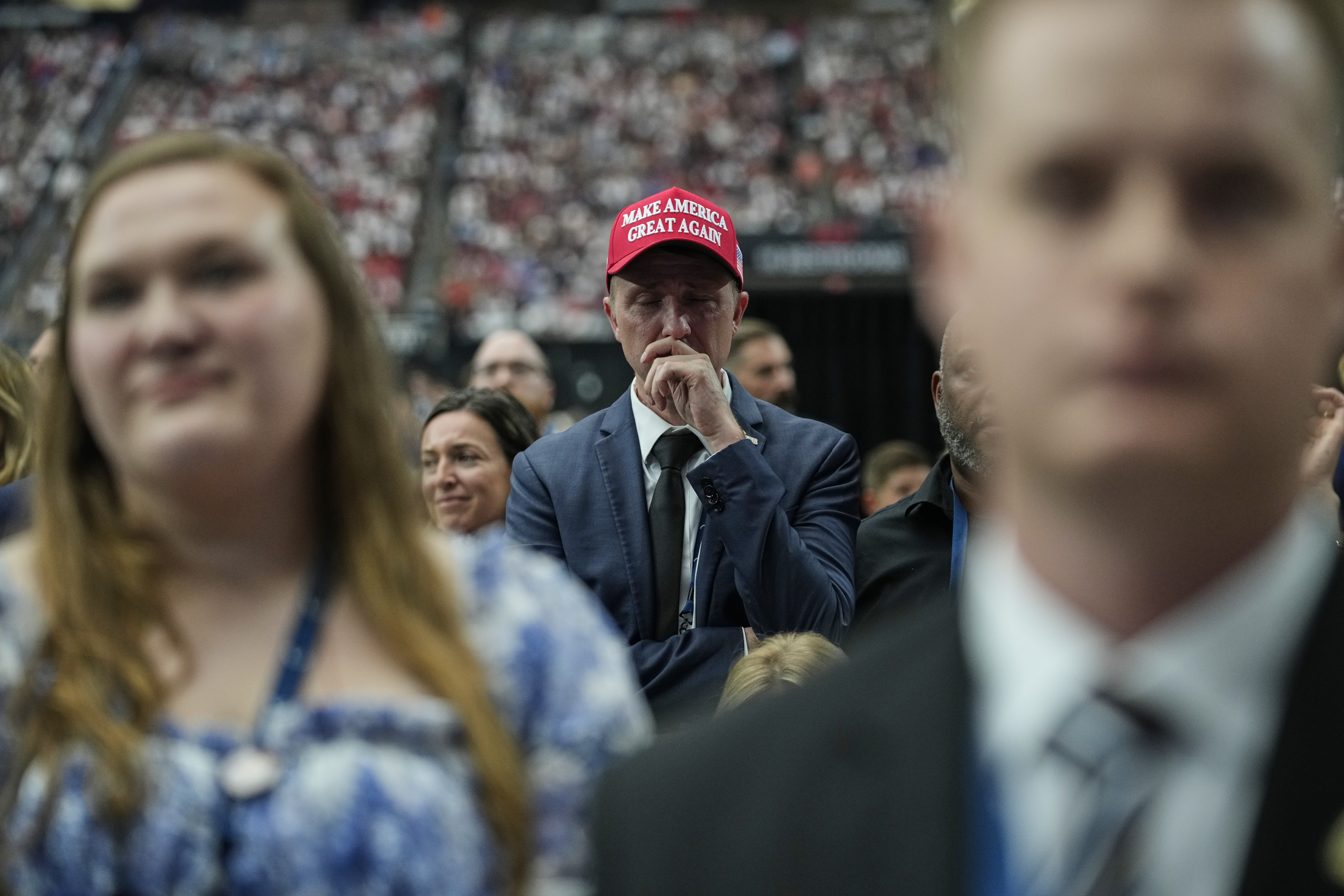 A man is overcome with emotion while watching a Charlie Kirk tribute video during a memorial for the conservative activist Sunday, Sept. 21, 2025, at State Farm Stadium in Glendale, Ariz. (John Locher - AP)