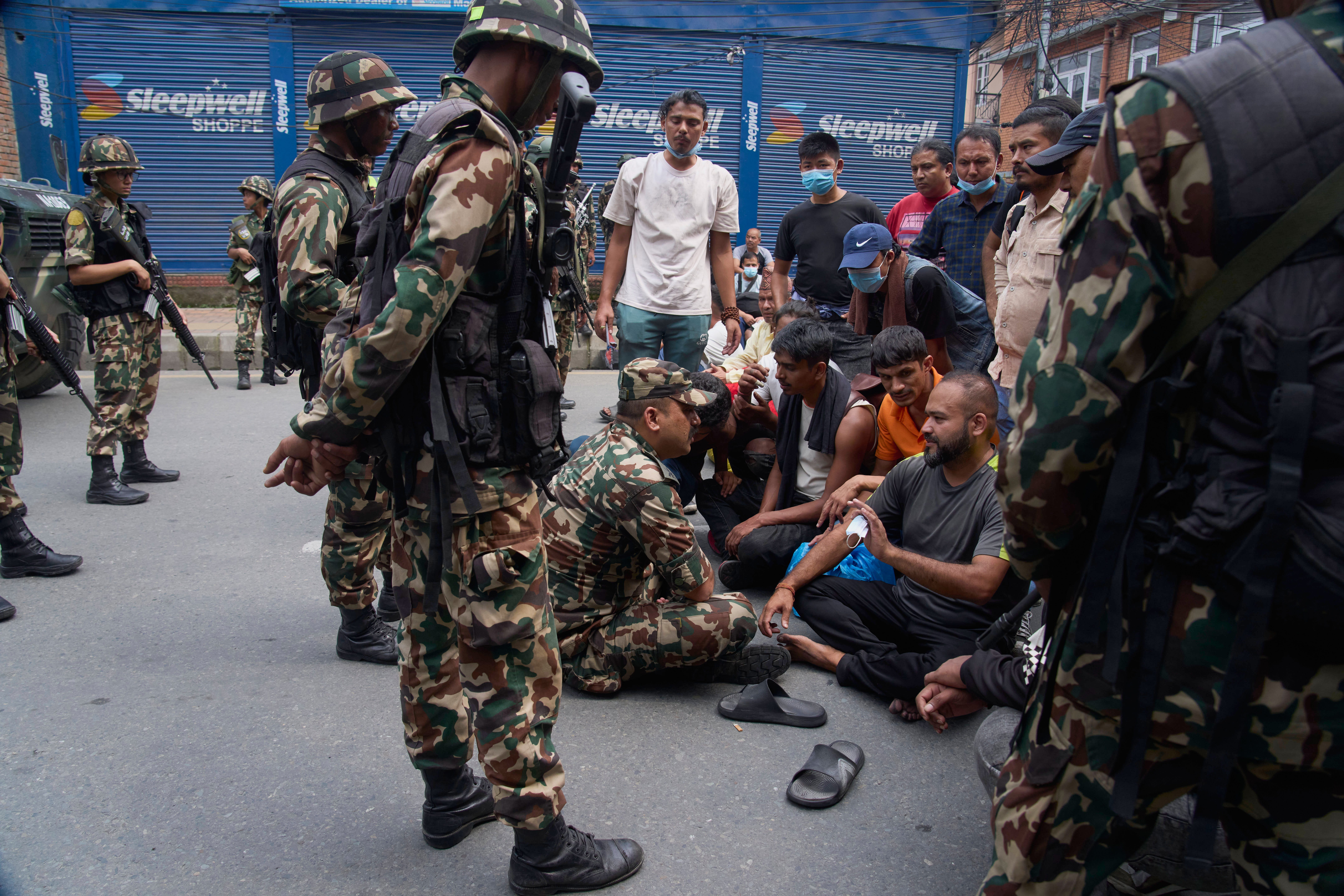 A Nepalese army personnel speaks to prisoners who escaped from Dilli Bazaar jail after being recaptured and refusing to return to prison in Kathmandu, Nepal, Wednesday, Sept. 10, 2025. (Niranjan Shrestha - AP)