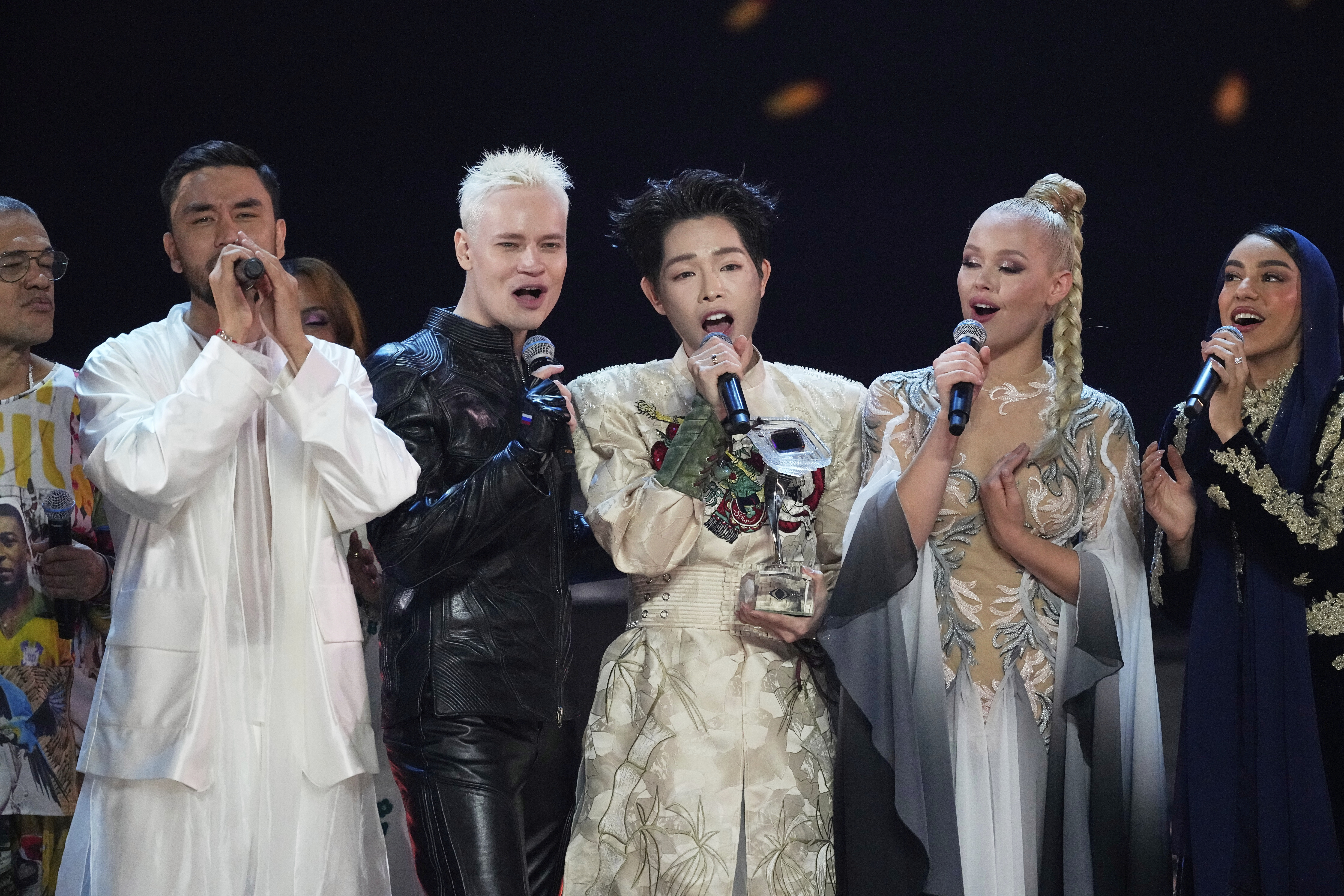 Vietnam's Duc Phuc, center, the winner of the International Music Competition 