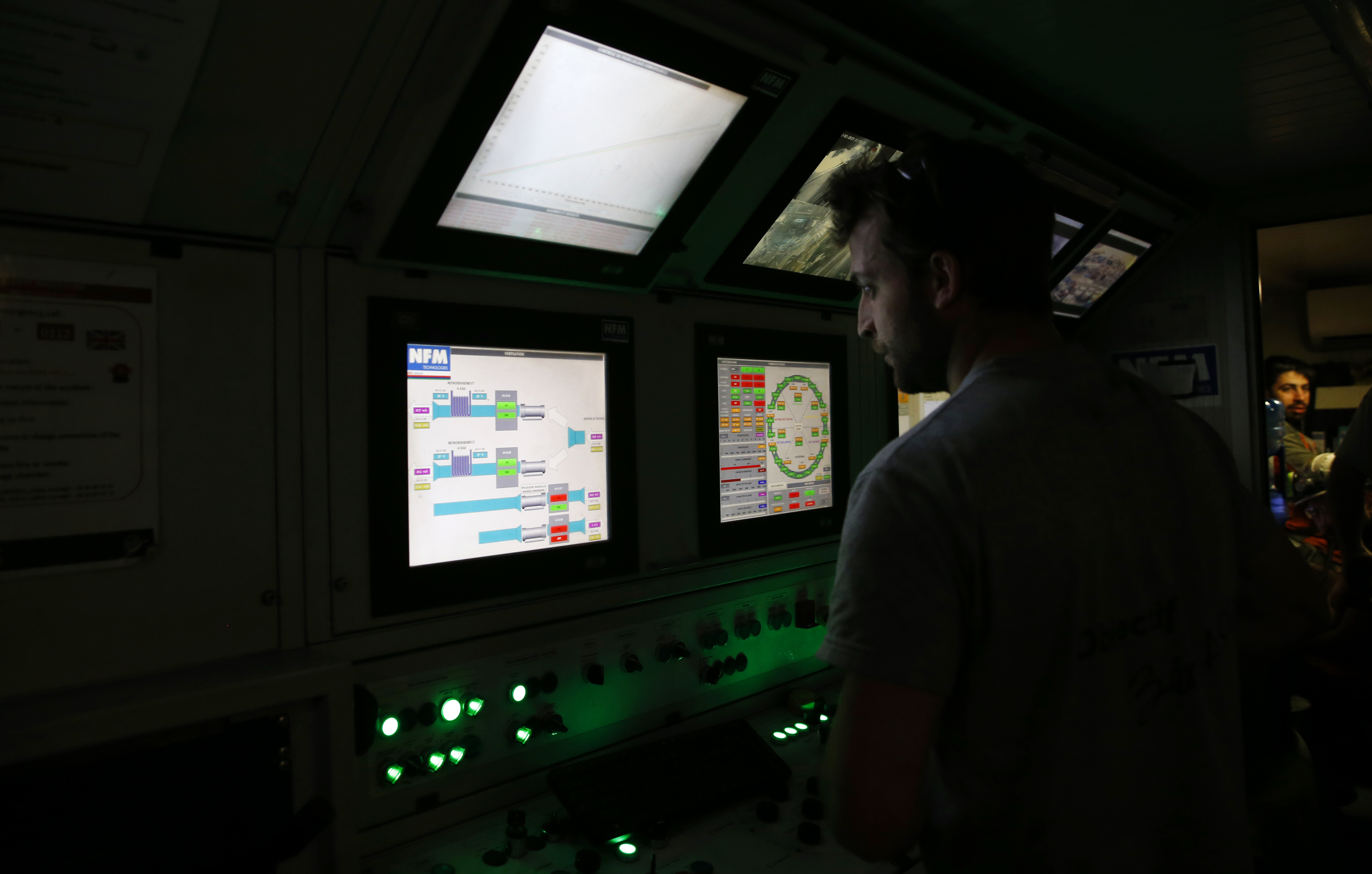 FILE- An engineer works in a pilot cabin of a 140-meter-long rock-eating machine dubbed