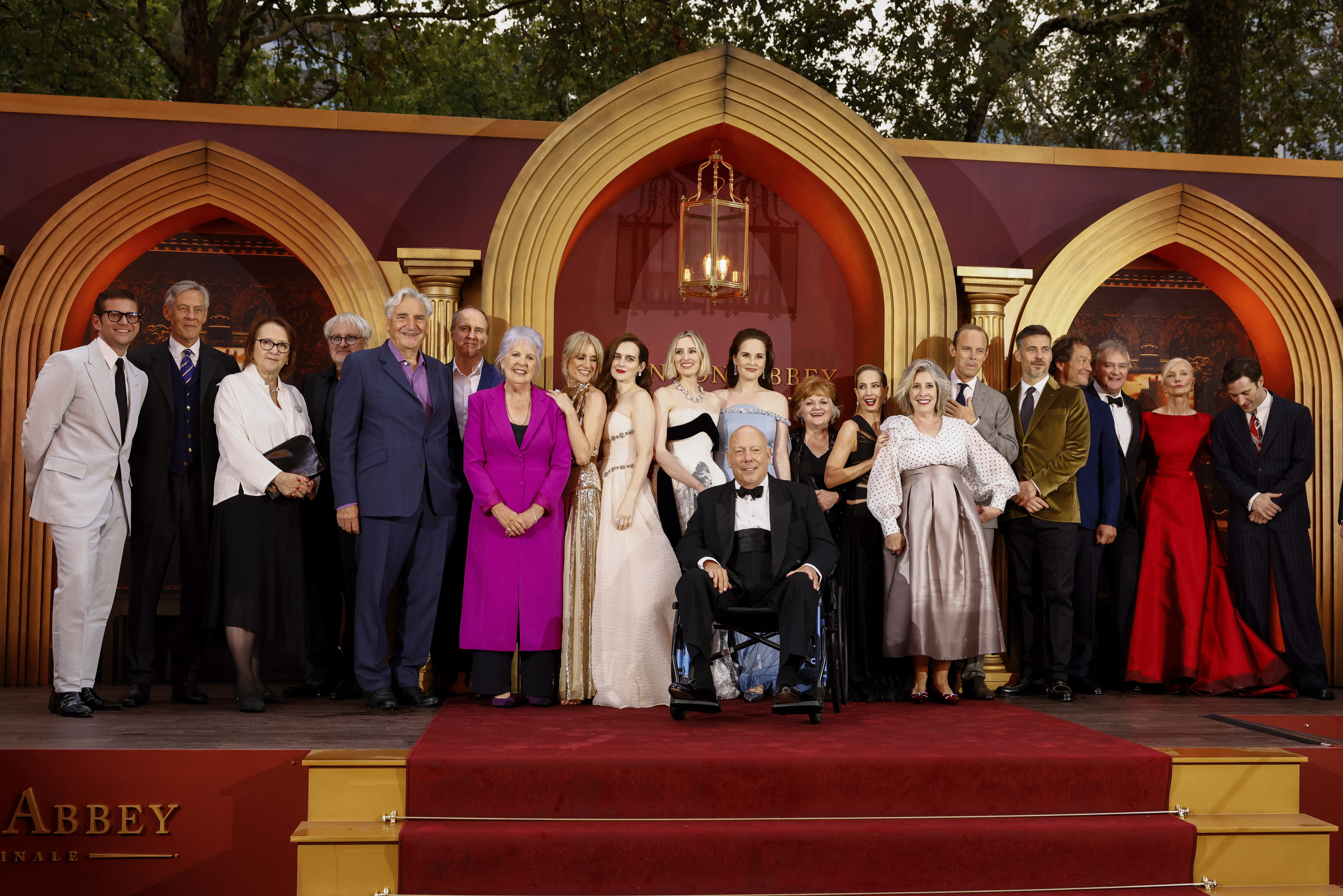 Allen Leech, from back left, Douglas Reith, producer Liz Trubridge, director Simon Curtis, Jim Carter, Kevin Doyle, Penelope Wilton, Raquel Cassidy, Sophie McShera, Laura Carmichael, Michelle Dockery, Lesley Nicol, Joanne Froggatt, Phyllis Logan, Harry Hadden-Paton, Rob James-Collier, Dominic West, Hugh Bonneville, Joely Richardson and Arty Froushan pose for photographers upon arrival at the world premiere of the film 'Downton Abbey: The Grand Finale' on Wednesday, Sept. 3, 2025, in London. (Millie Turner - Invision)