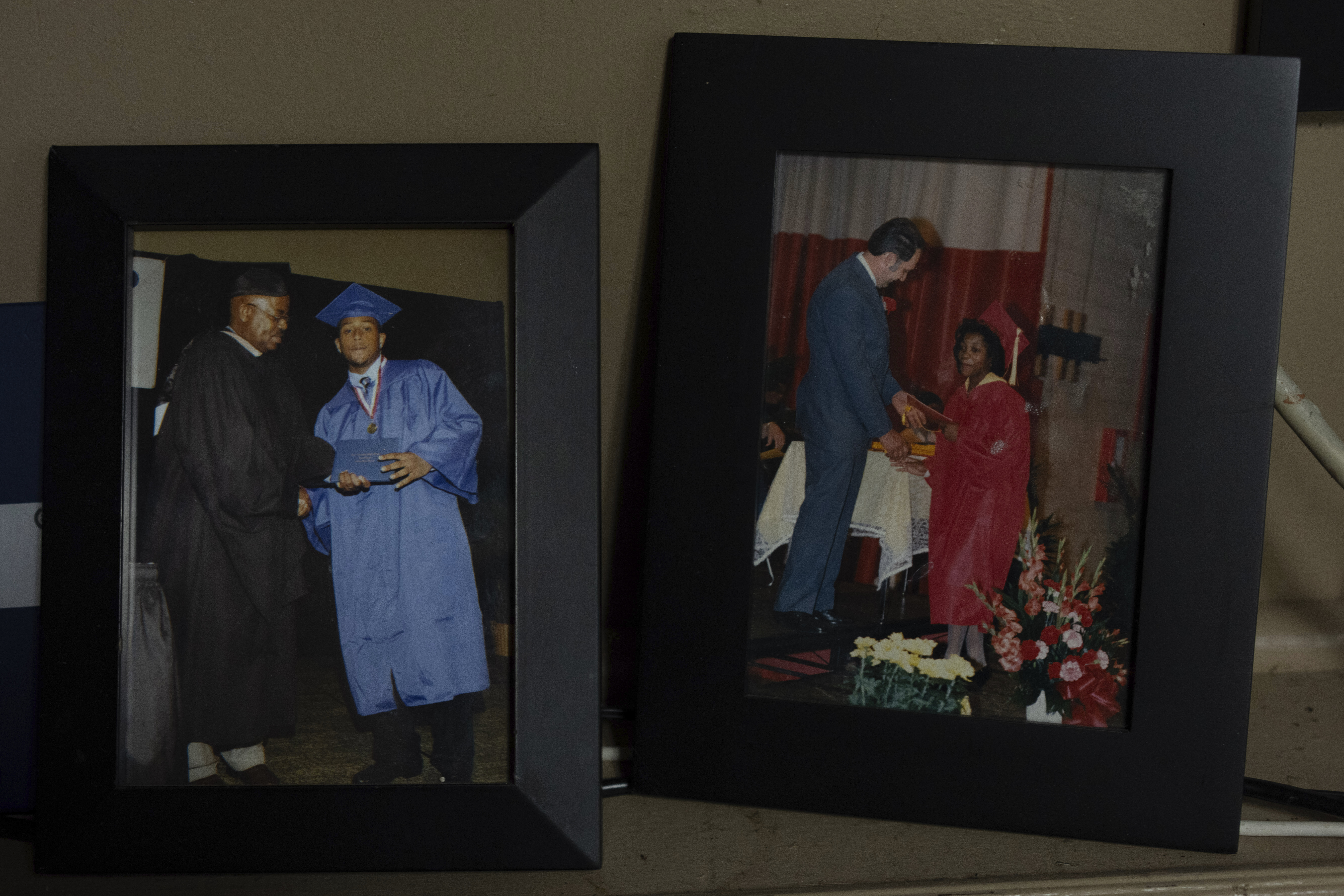 Framed photos of two of Delphine Cherry's children are displayed in her home Friday, Sept. 5, 2025, in Hazel Crest, Ill. Cherry lost two children, Tyler Randolph, left, seen, graduating from high school, and Tyesa Abney, right, seen, graduating from the eight grade, to shootings in and near Chicago. (Carolyn Kaster - AP)