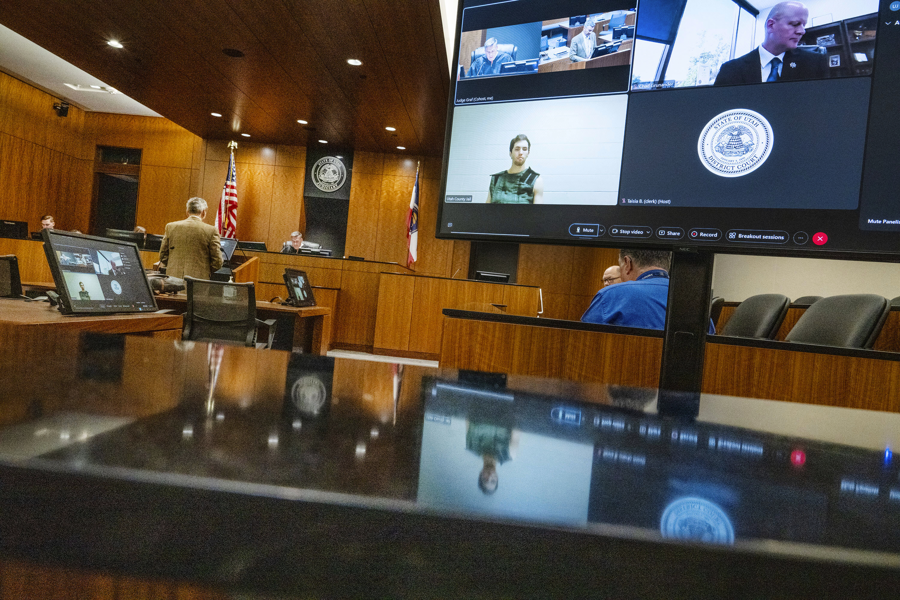 Defense attorney Greg Skordas, left, speaks before judge Tony Graf, back center left, as Tyler Robinson, accused of fatally shooting Charlie Kirk, attends a virtual court hearing from prison on Tuesday, Sept. 16, 2025, in Provo, Utah. (Scott G Winterton - Pool The Deseret News)