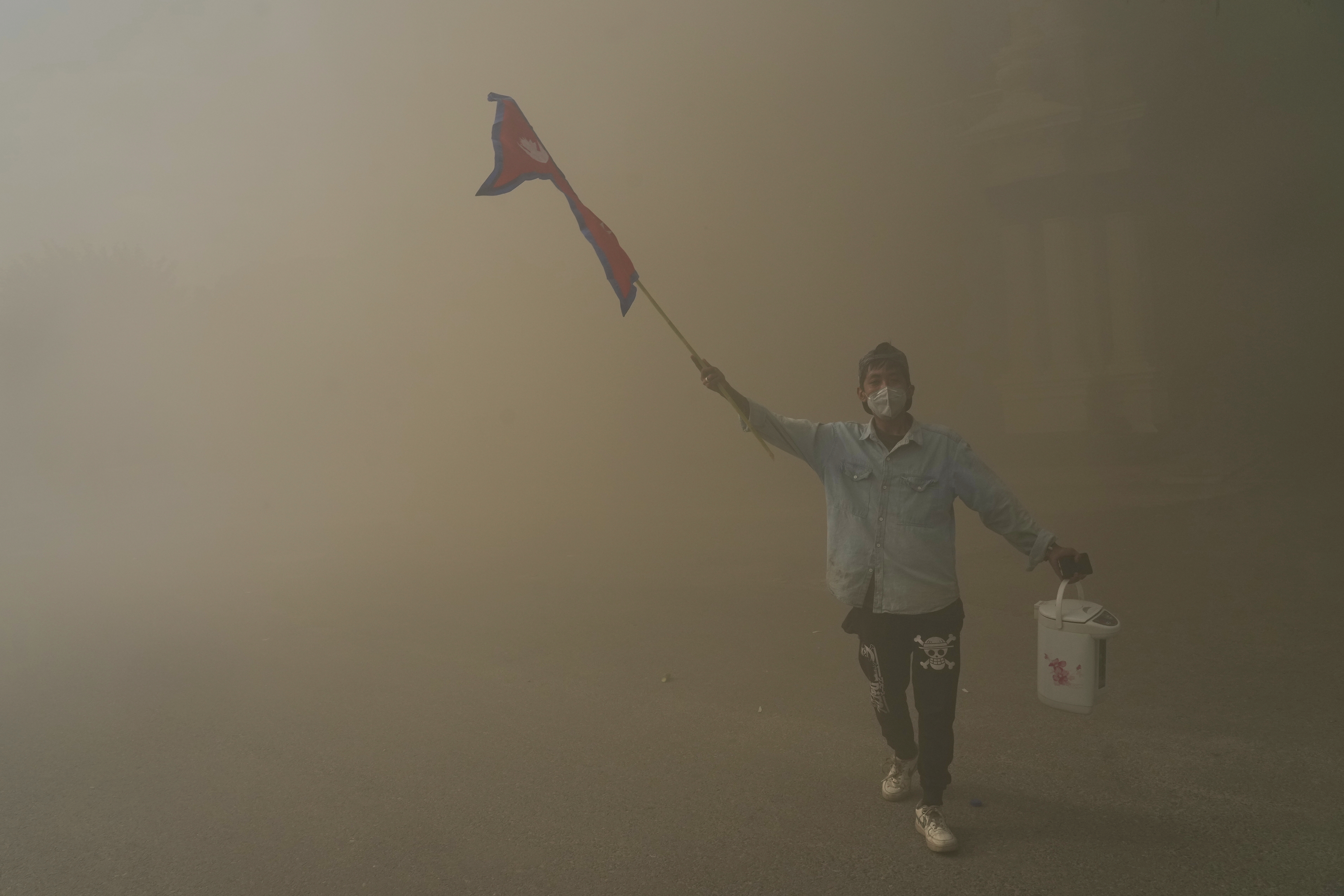 A protester celebrates at the Singha Durbar, the seat of Nepal's government's various ministries and offices, after it was set on fire during a protest against social media ban and corruption in Kathmandu, Nepal, Tuesday, Sept. 9, 2025. (Niranjan Shrestha - AP)