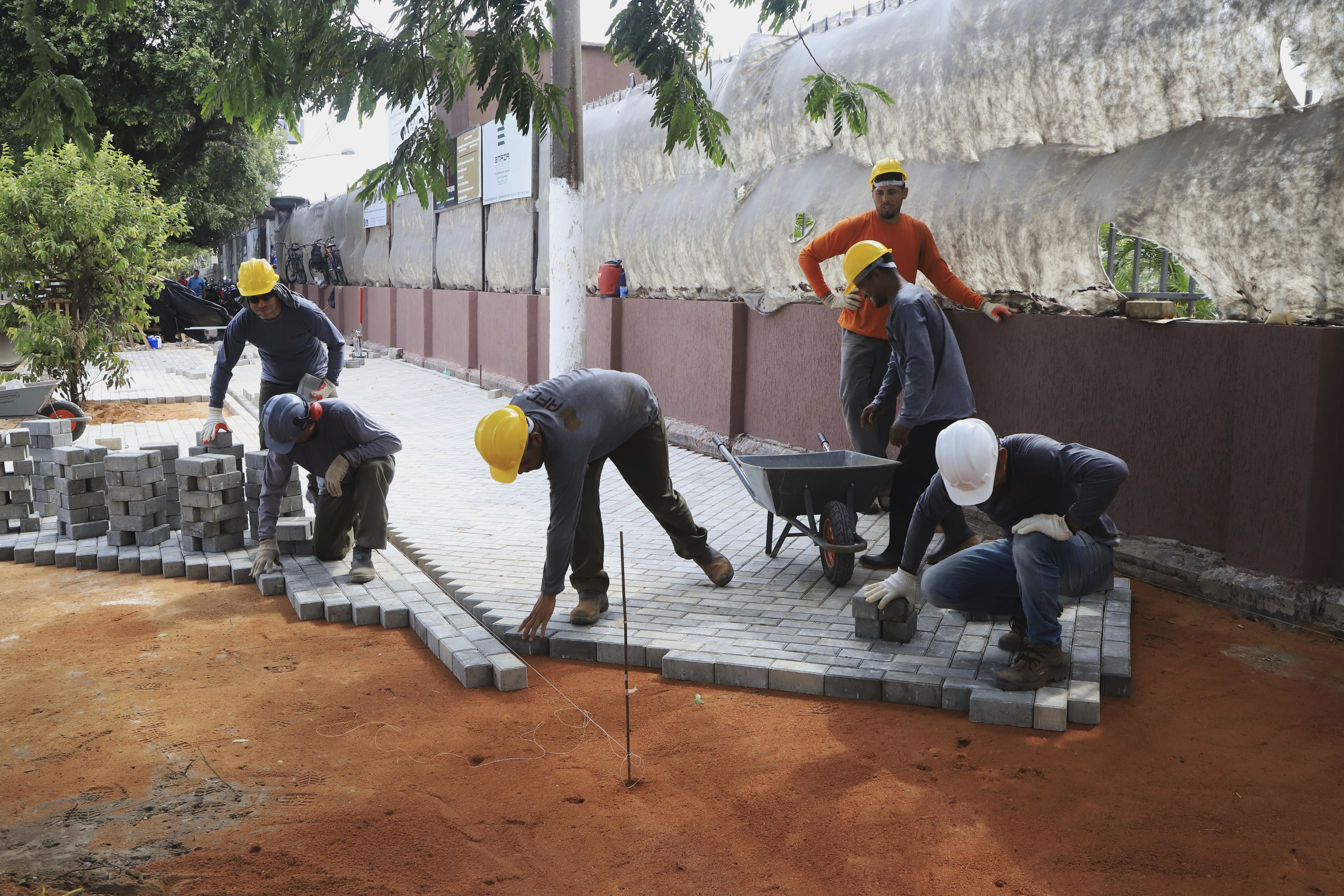 Workers prepare a sidewalk on the banks of the Guajara Bay as part of preparations for upcoming COP30 U.N. Climate Summit, in Belem, Brazil, Sept.18, 2025. (Paulo Santos - AP)