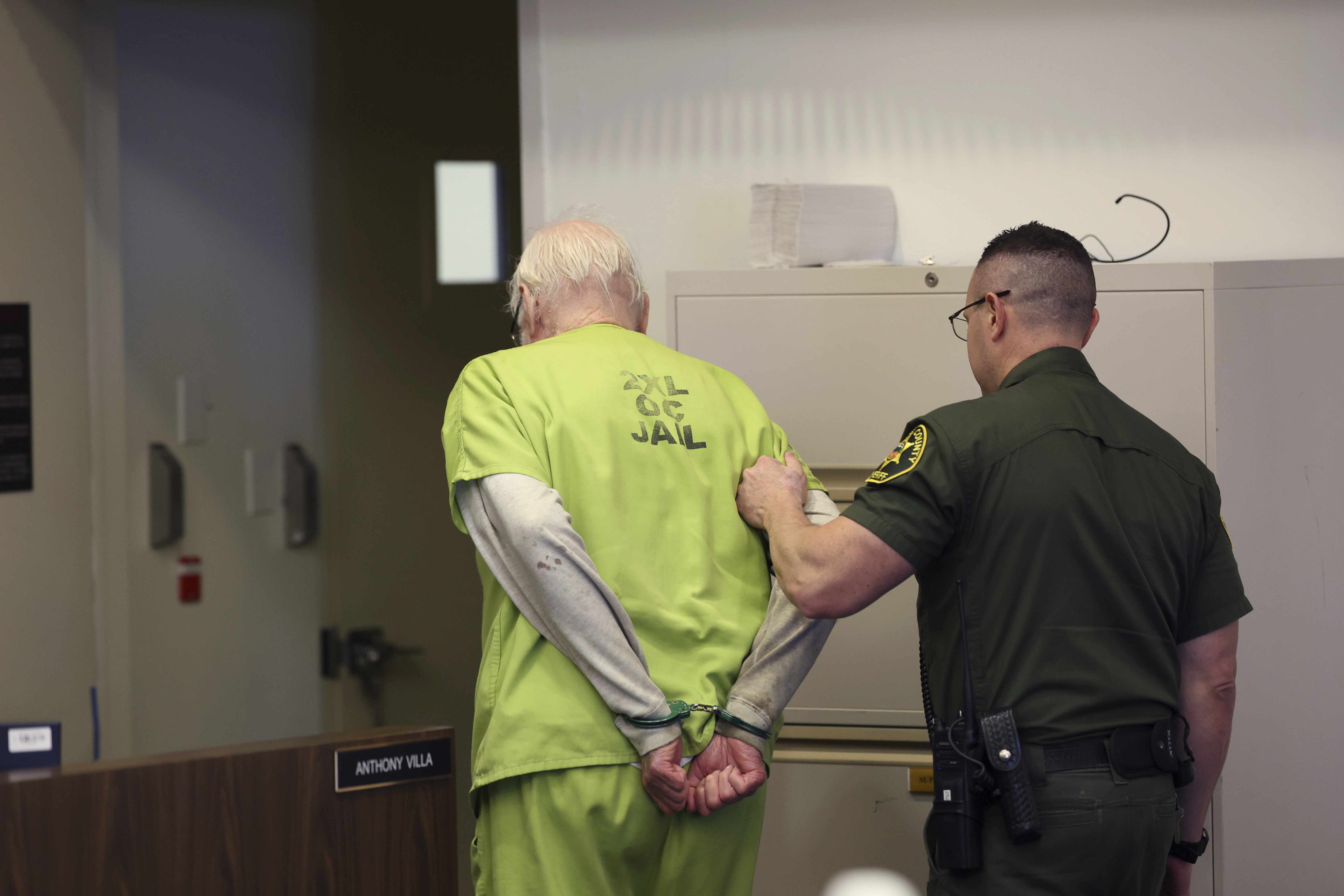 Orange County Superior Court Judge Jeffrey Ferguson is removed from court after being sentenced to 35 years to life in prison after his second-degree murder conviction for shooting his wife following an hours-long argument at the Central Justice Center in Santa Ana, Calif. Wednesday, Sept. 17, 2025. (Allen J. Schaben - Pool Los Angeles Times)