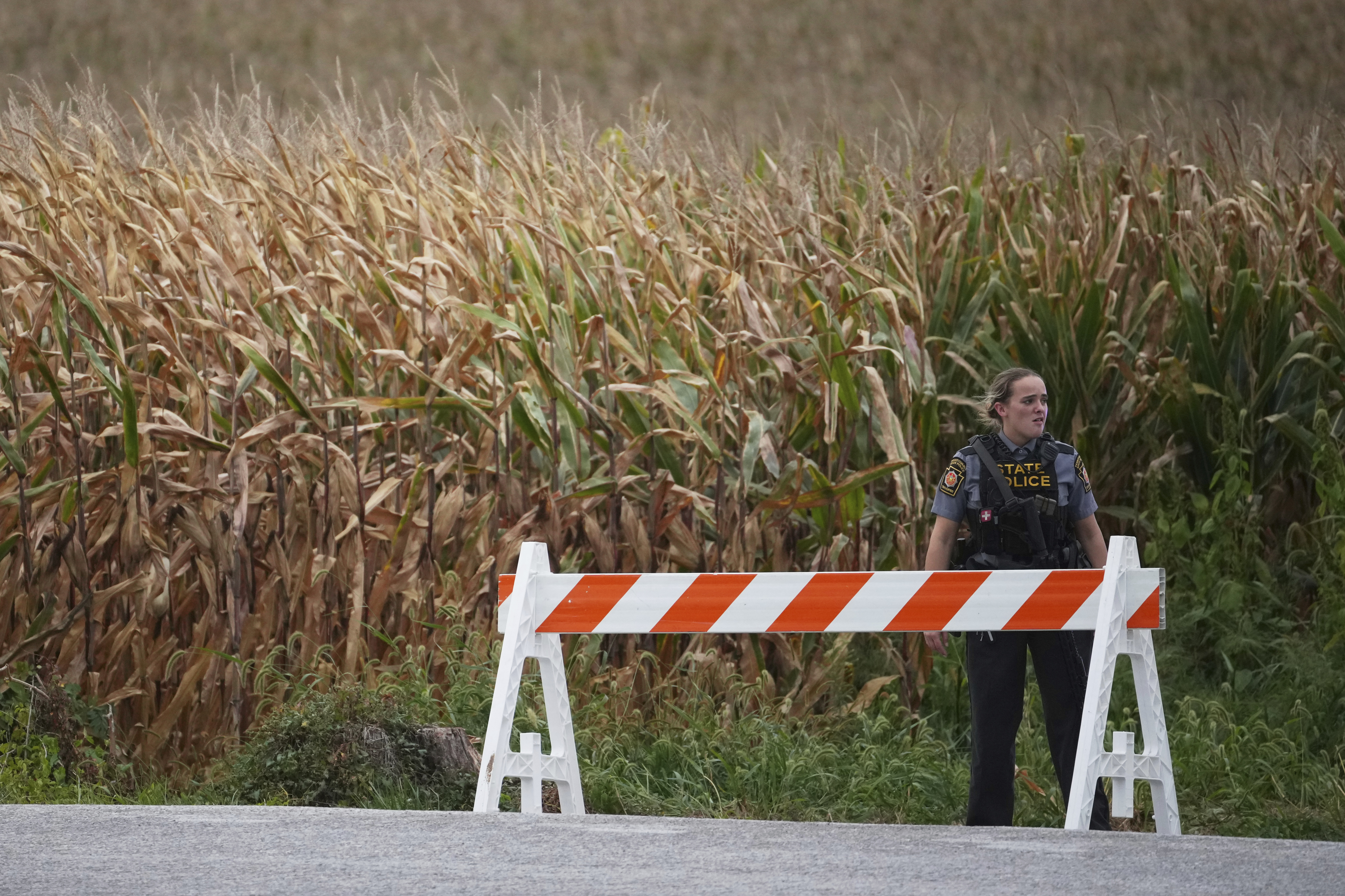 A Pennsylvania state police trooper blocks a road after multiple police officers were shot and killed on Wednesday, Sept. 17, 2025, in North Codorus, Pa. (Matt Slocum - AP)