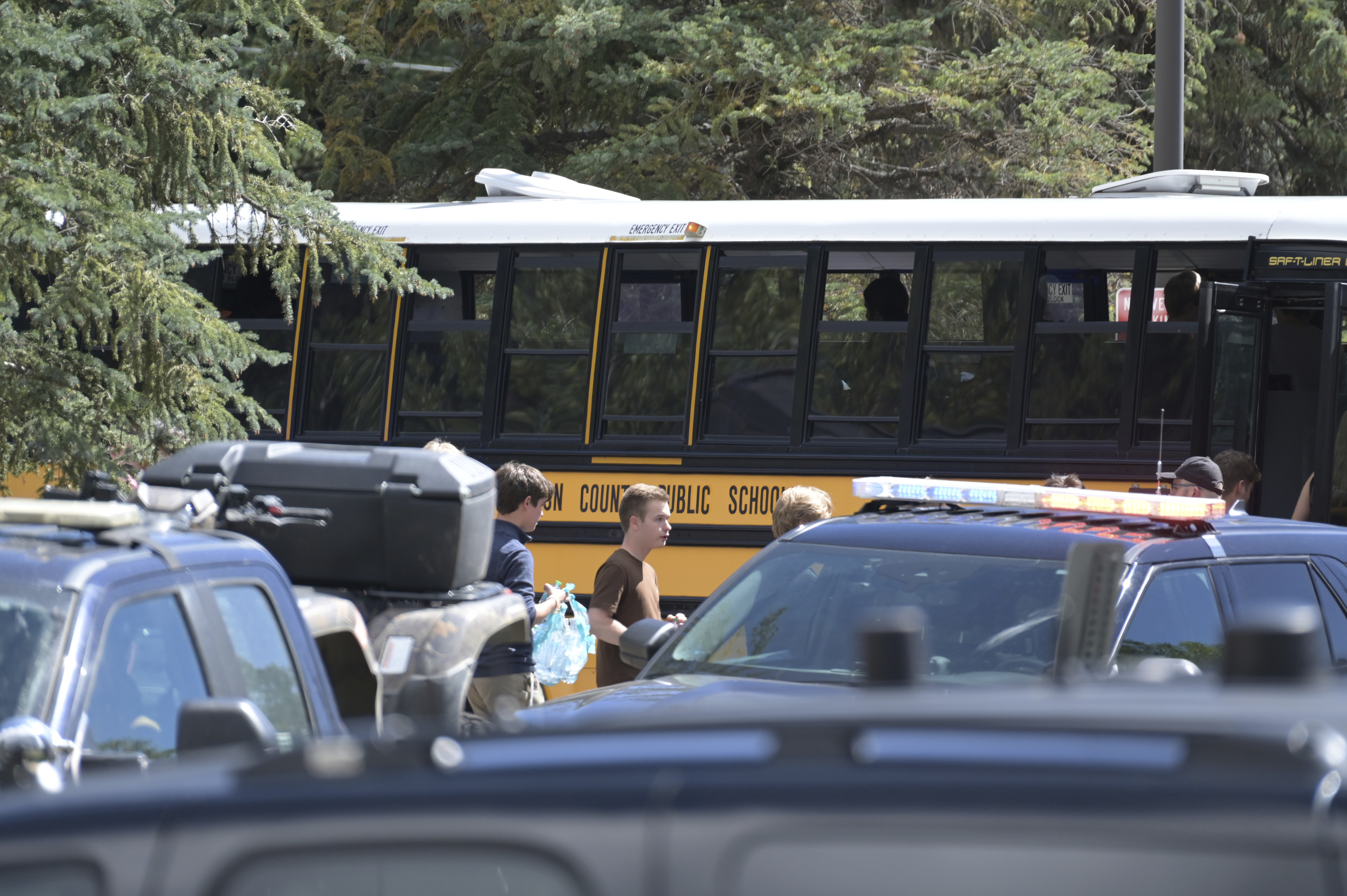 Students board a bus amid heavy police presence at the Evergreen Library after a shooting at Evergreen High School in Evergreen, Colo., on Wednesday, Sept. 10, 2025. (Hyoung Chang - The Denver Post)