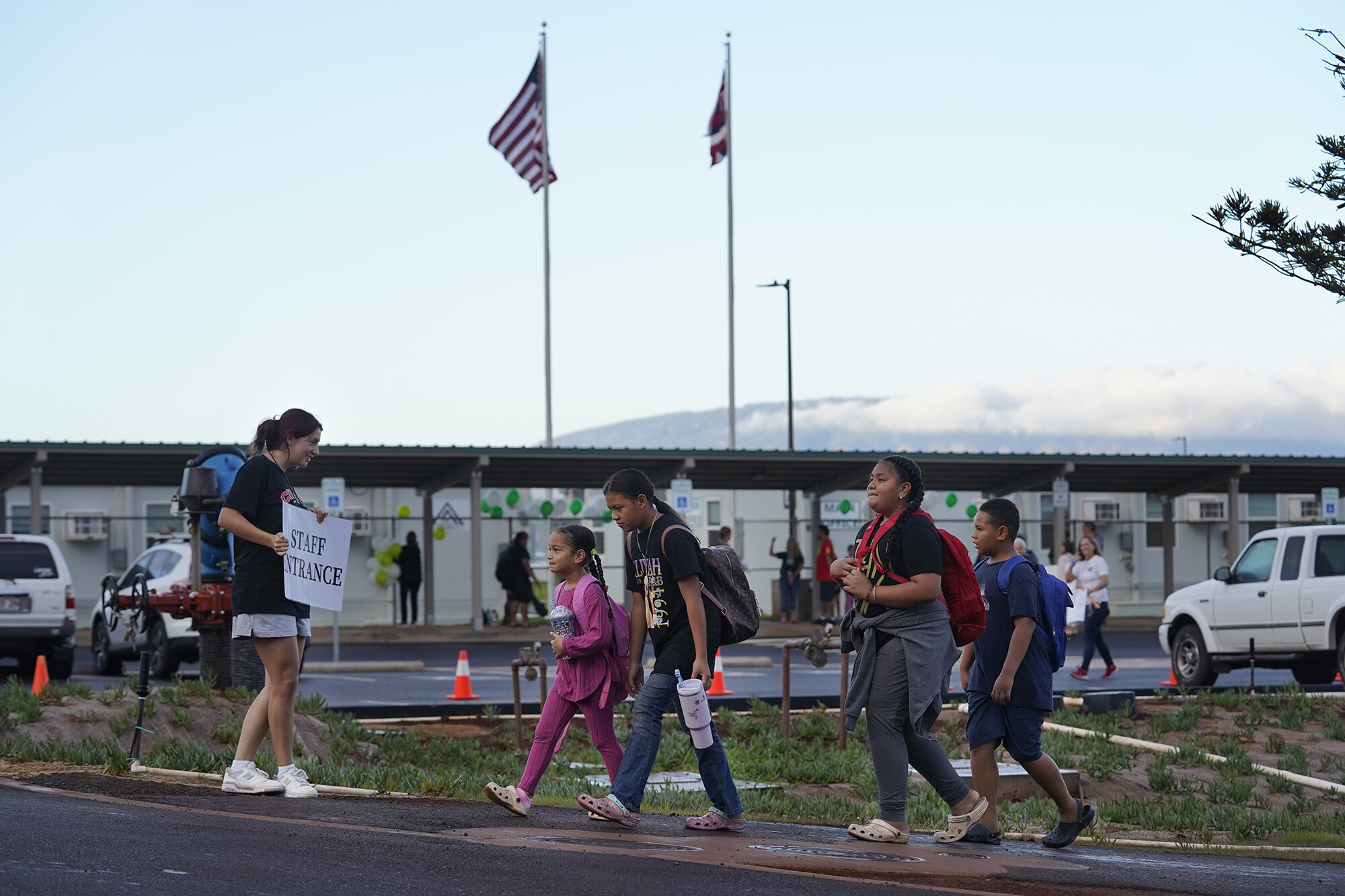 Students walk to the temporary Pulelehua campus of King Kamehameha III Elementary School in Lahaina, Hawaii, on Monday, April 1, 2024. The original school was destroyed in the August 2023, fires. (Kevin Fujii - Honolulu Civil Beat)