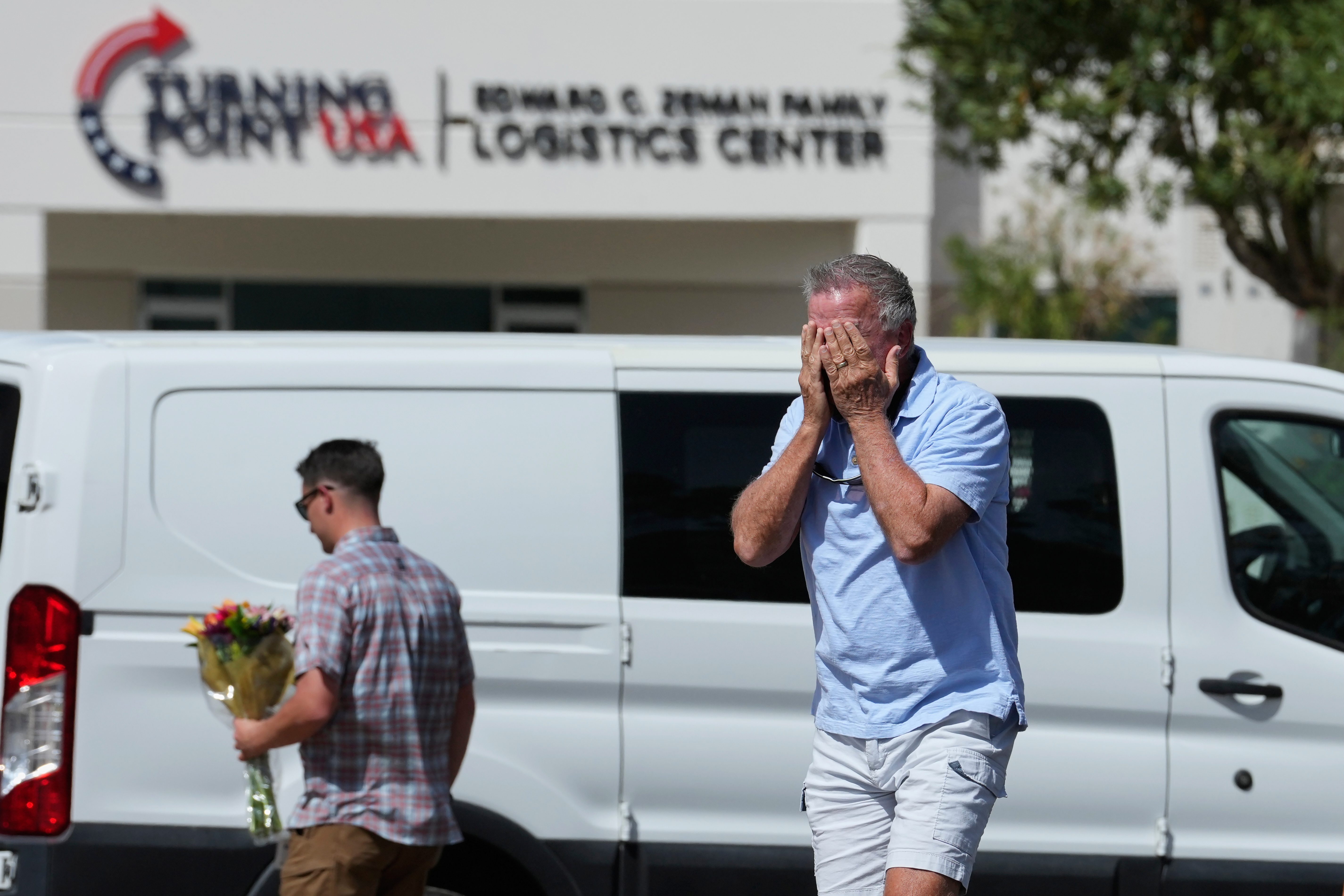A well-wisher is overcome after dropping off flowers, Wednesday, Sept. 10, 2025, at the national headquarters of Turning Point USA in Phoenix, following the shooting death of Charlie Kirk, the 31-year-old CEO of the organization, at a Utah college. (Ross D. Franklin - AP)