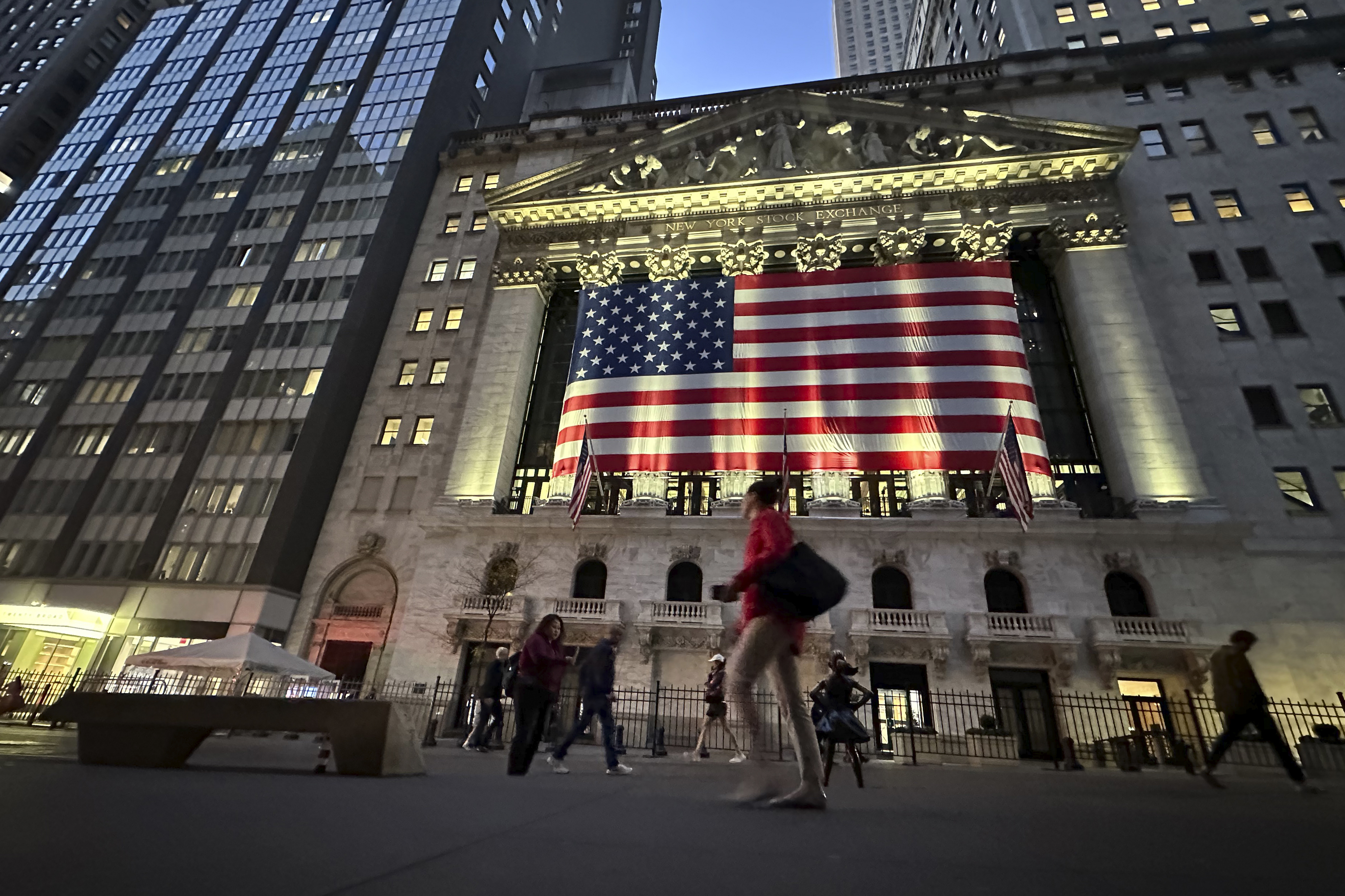 FILE - People pass the New York Stock Exchange on Nov. 5, 2024, in New York. (Peter Morgan - AP)