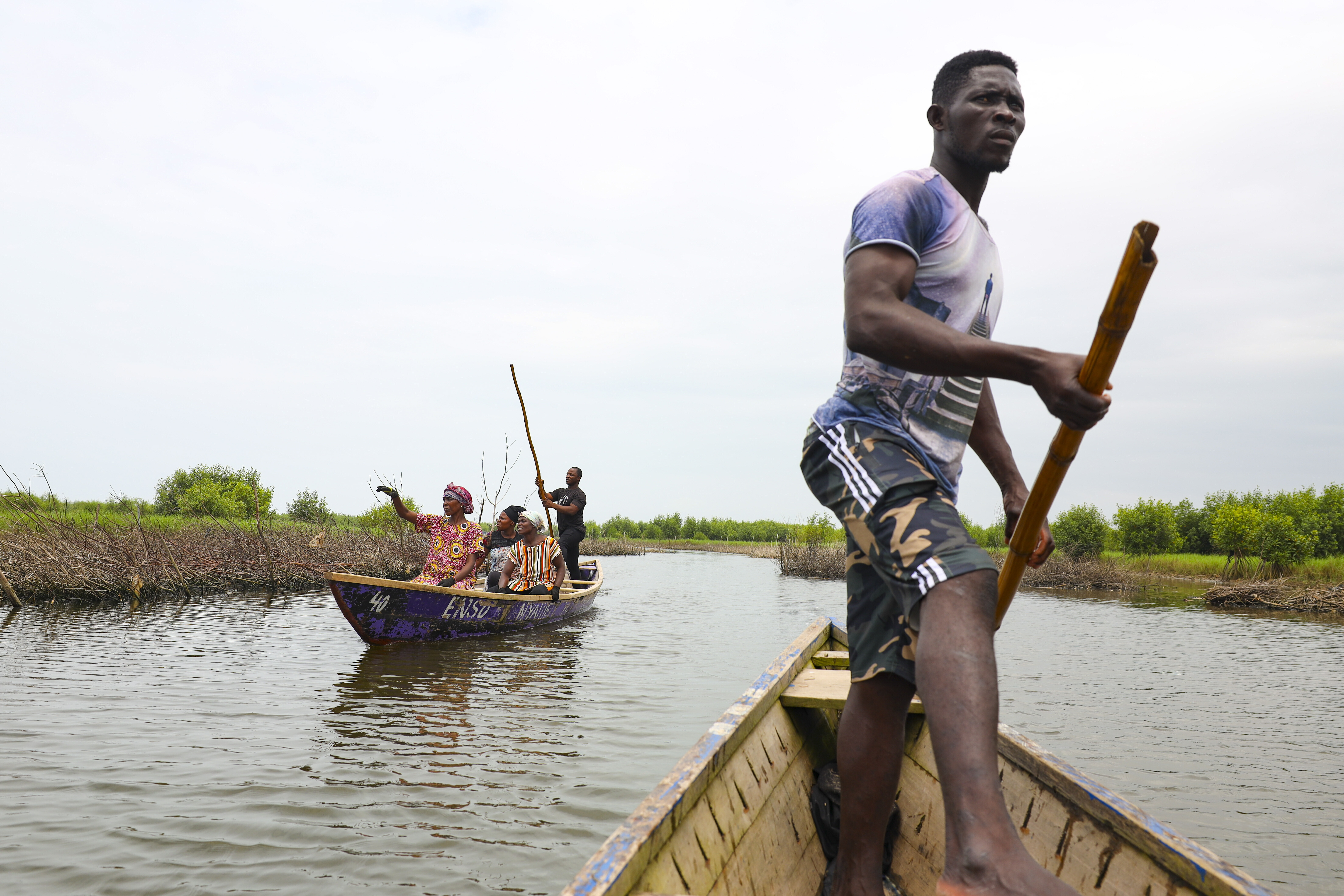 Women ride boats to harvest oysters at Tsokomey, Ghana, Aug. 6, 2025. (Misper Apawu - AP)