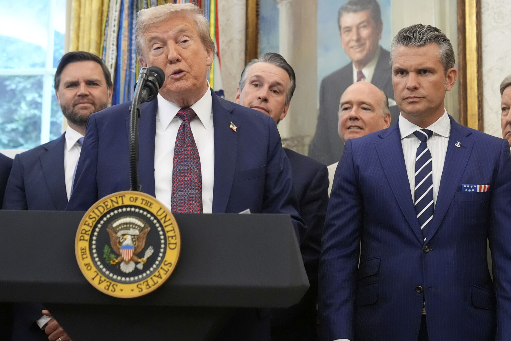 President Donald Trump speaks about the relocation of U.S. Space Command headquarters from Colorado to Alabama in the Oval Office of the White House, Tuesday, Sept. 2, 2025, in Washington, as Vice President JD Vance and Defense Secretary Pete Hegseth listen. (Mark Schiefelbein - AP)