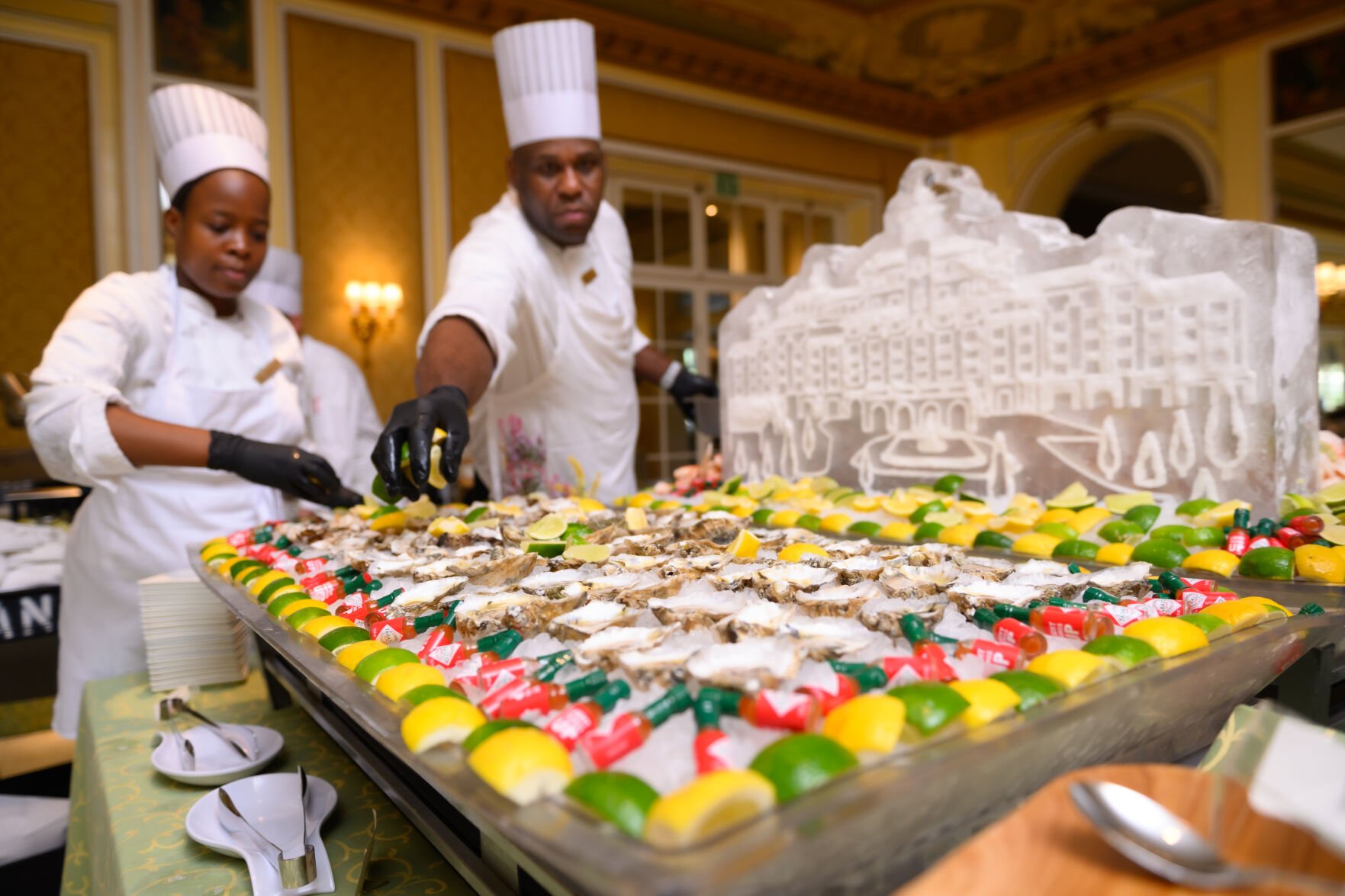 Masesupo Riba and Troy Mckenzie prepare a display of seasonal east coast oysters before the arrival of guests for Sunday Brunch in the Lake Terrace Dining Room at the Broadmoor Hotel June 29, 2025. Photo by Mark Reis (Mark Reis)