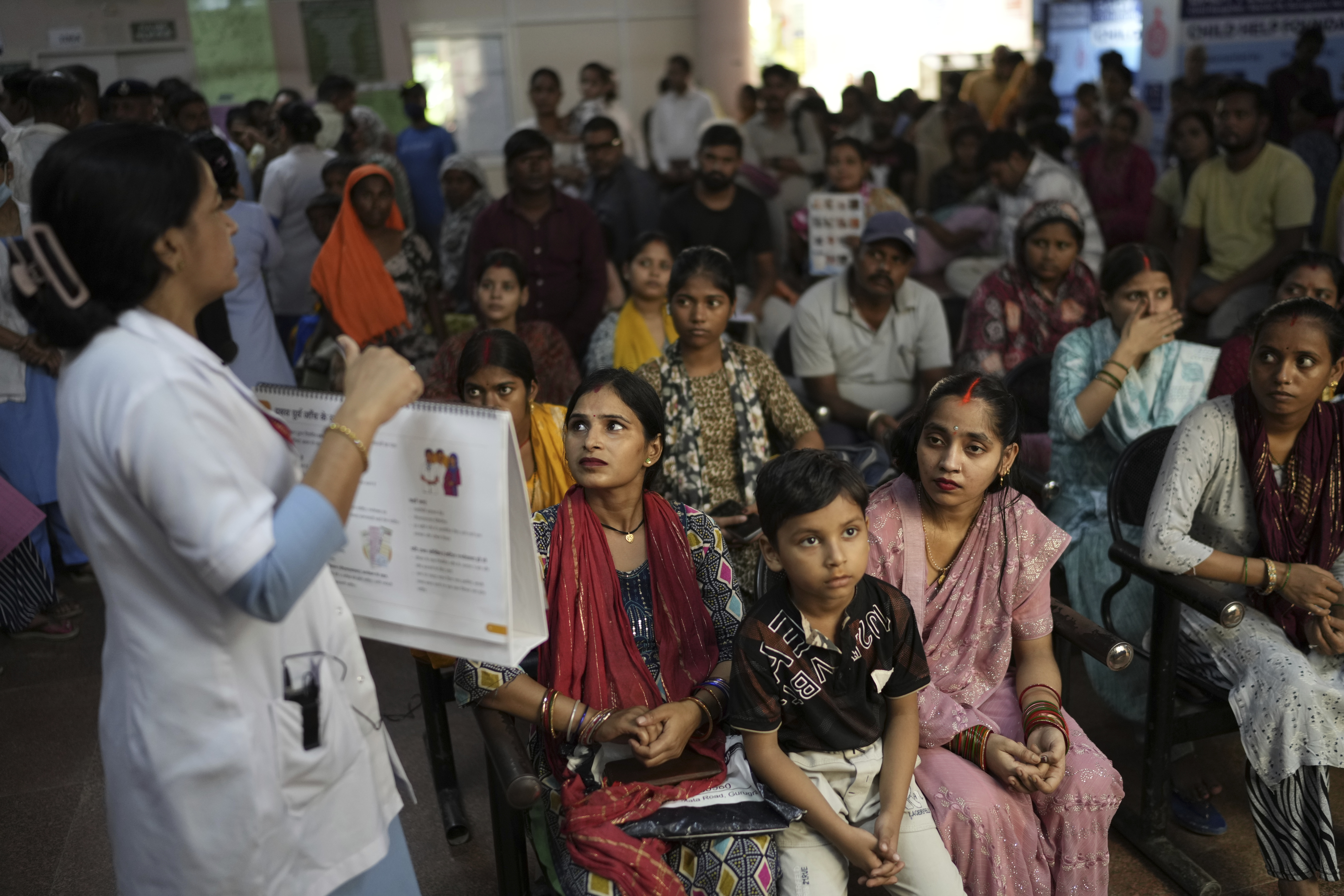 Pregnant women listen to a nurse giving antenatal Care Companion Program (CCP) advise in a government hospital in Gurugram, a satellite city of New Delhi, India, on Aug. 7, 2025. (Manish Swarup - AP)