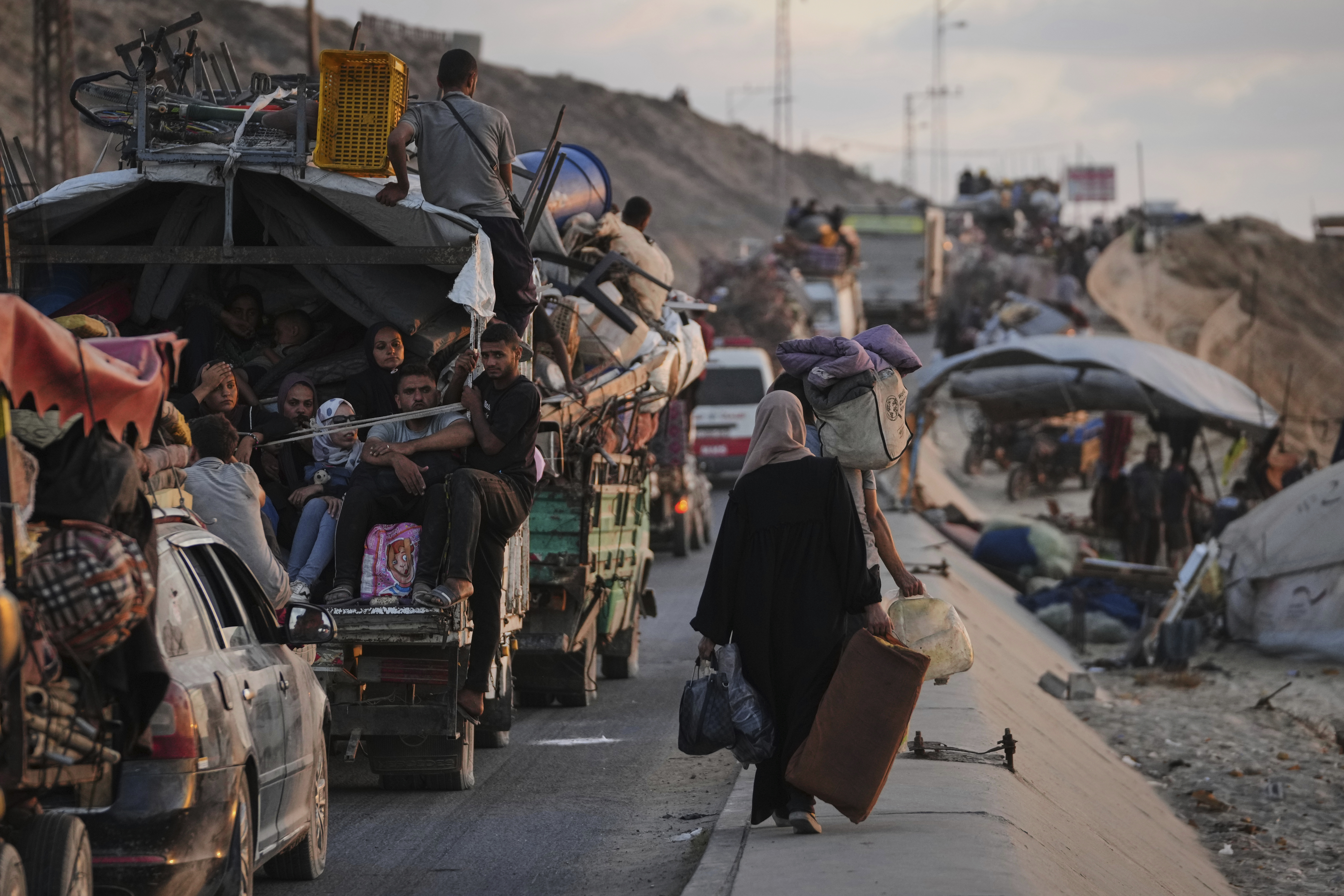 Displaced Palestinians fleeing northern Gaza carry their belongings along the coastal road toward southern Gaza, Thursday, Sept. 11, 2025, after the Israeli army issued evacuation orders from Gaza City. (Jehad Alshrafi - AP)