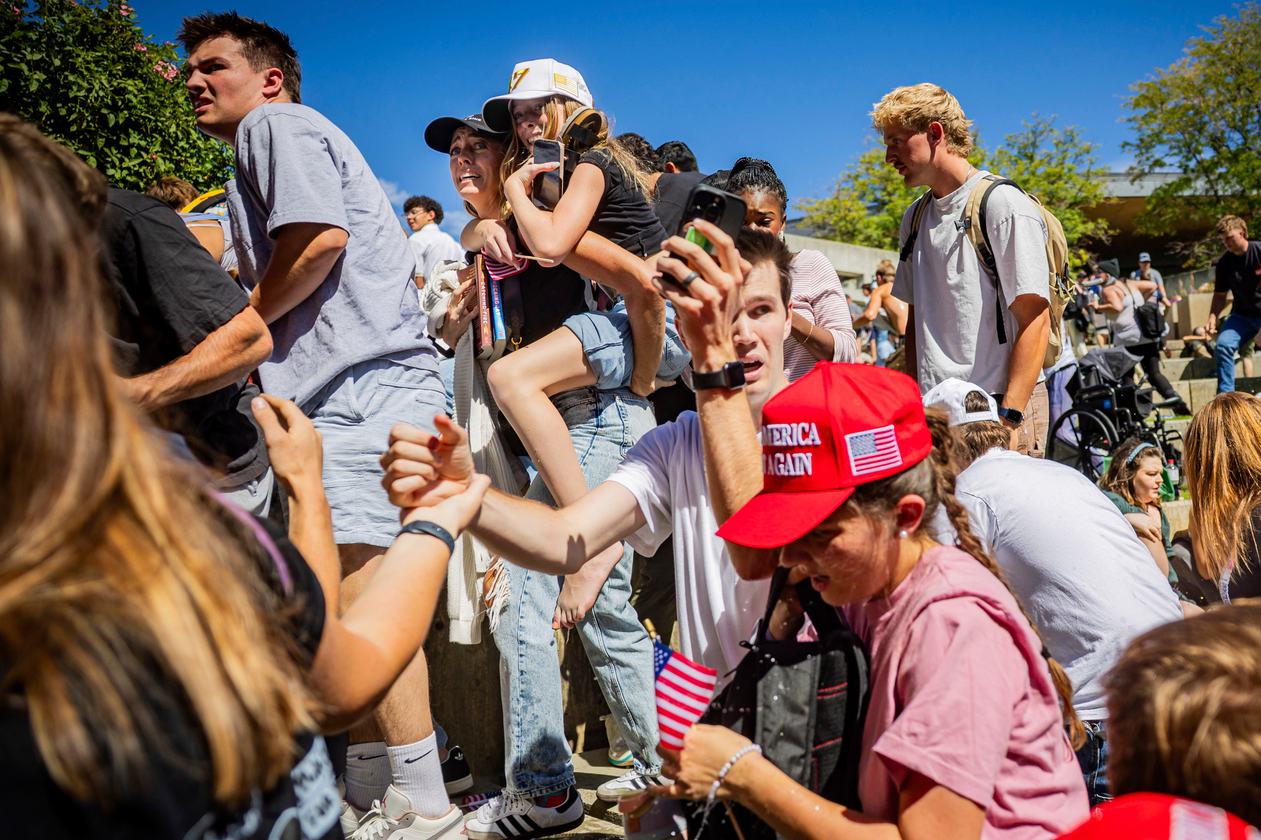 The crowd reacts after Charlie Kirk, the CEO and co-founder of the conservative youth organization Turning Point USA, is shot at the Utah Valley University Wednesday, Sept. 10, 2025, in Orem, Utah. (Tess Crowley - The Deseret News)